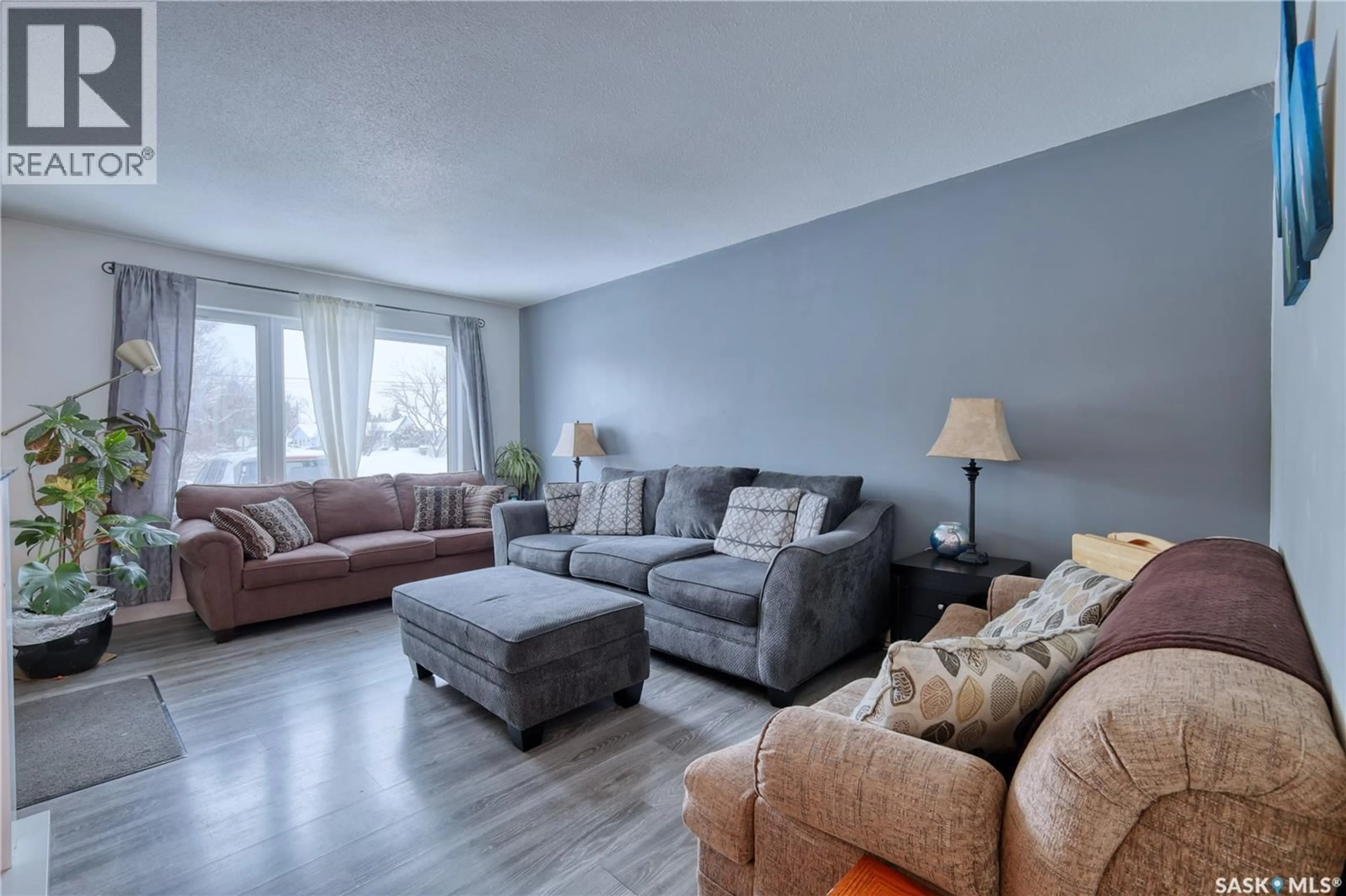 Living room with furniture, wood/laminate floor for 313 CENTENNIAL BOULEVARD, Warman Saskatchewan S0K4S0