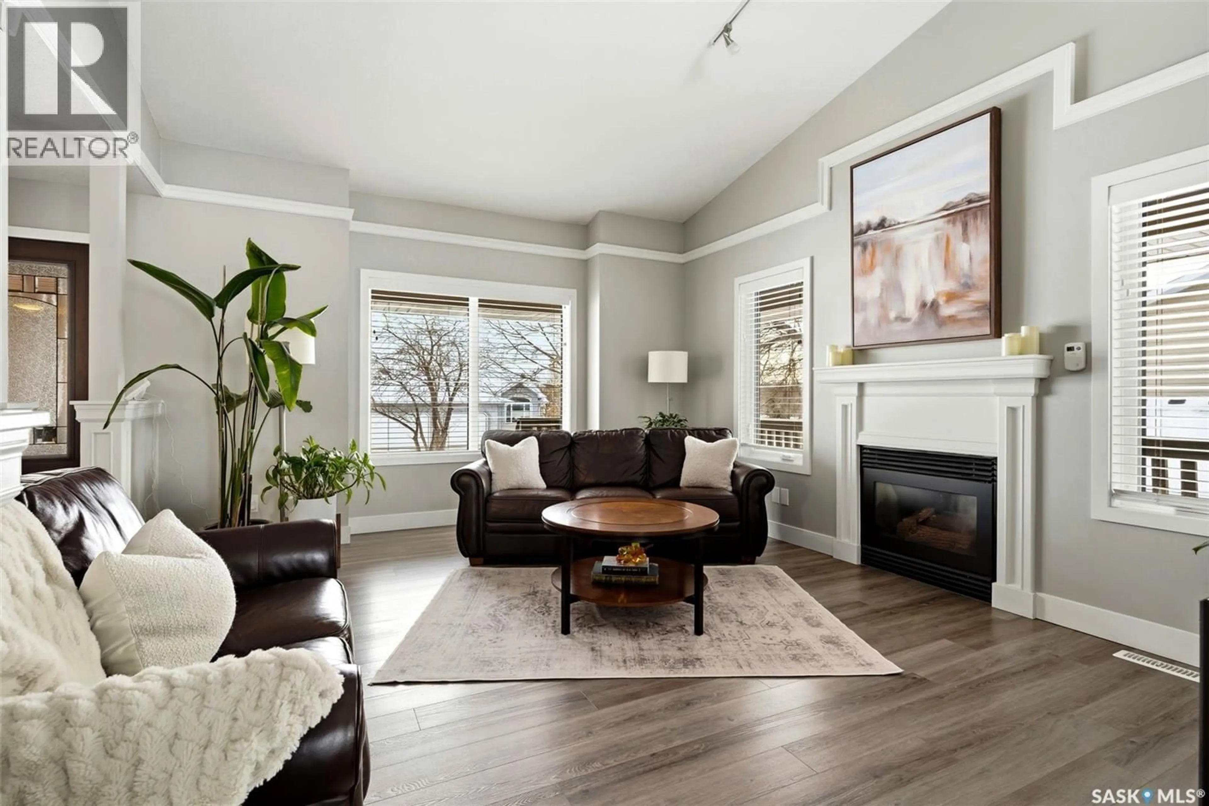 Living room with furniture, wood/laminate floor for 30 COTTONWOOD PLACE, Lumsden Saskatchewan S0G3C0