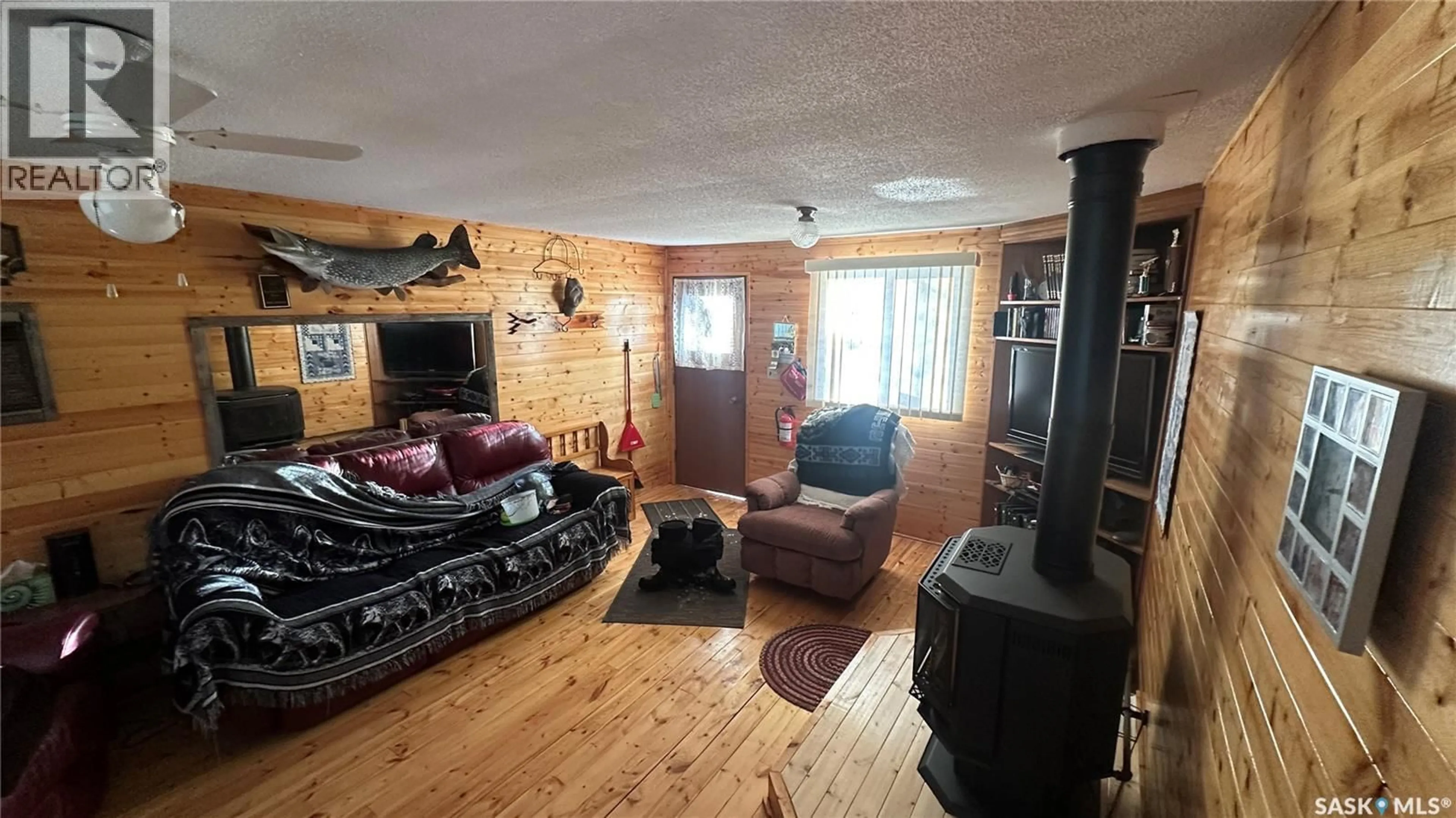 Living room with furniture, wood/laminate floor for 102 LAKEVIEW DRIVE, Tobin Lake Saskatchewan S0E1E0