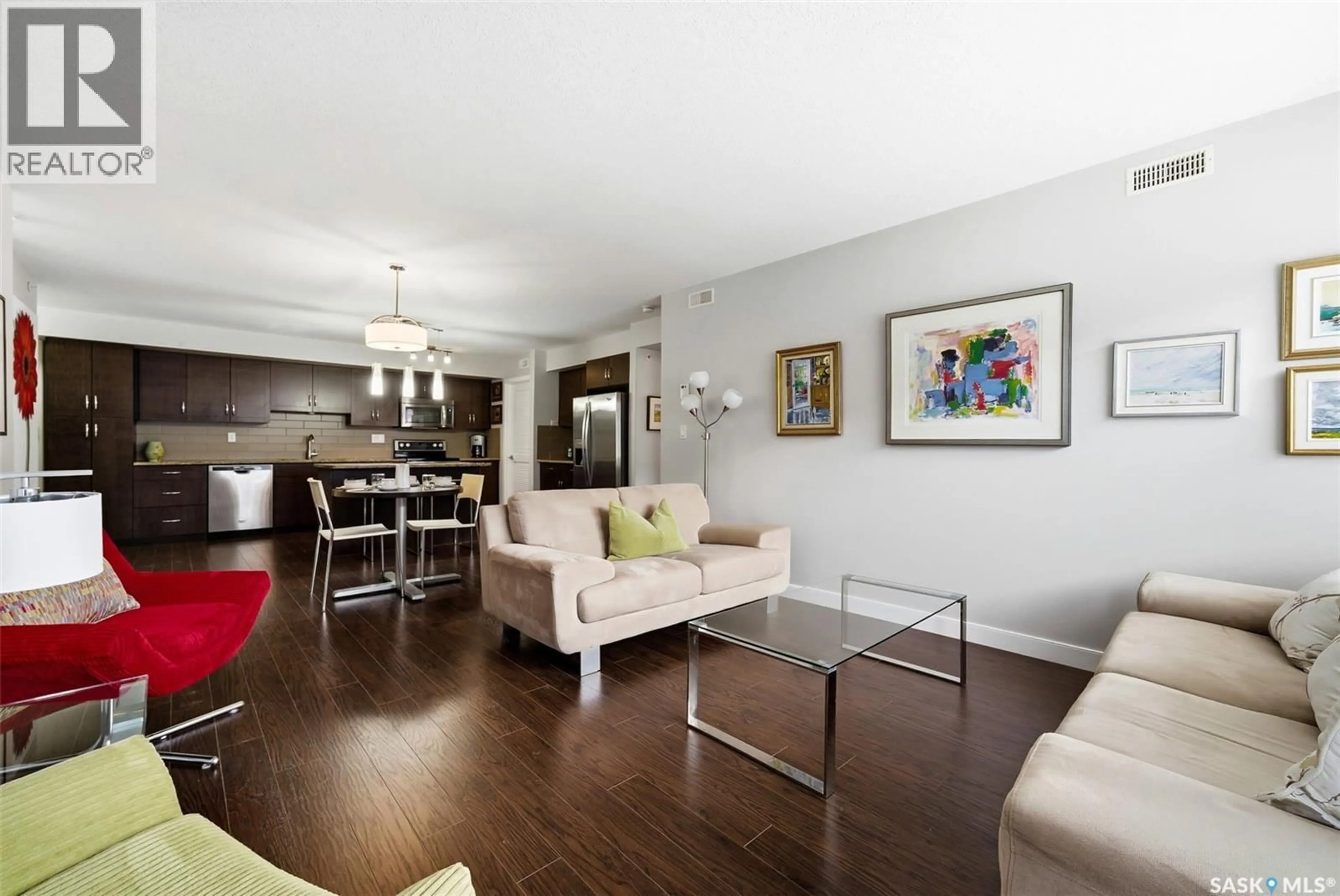 Living room with furniture, wood/laminate floor for 309 - 2321 WINDSOR PARK ROAD, Regina Saskatchewan S4V3N2