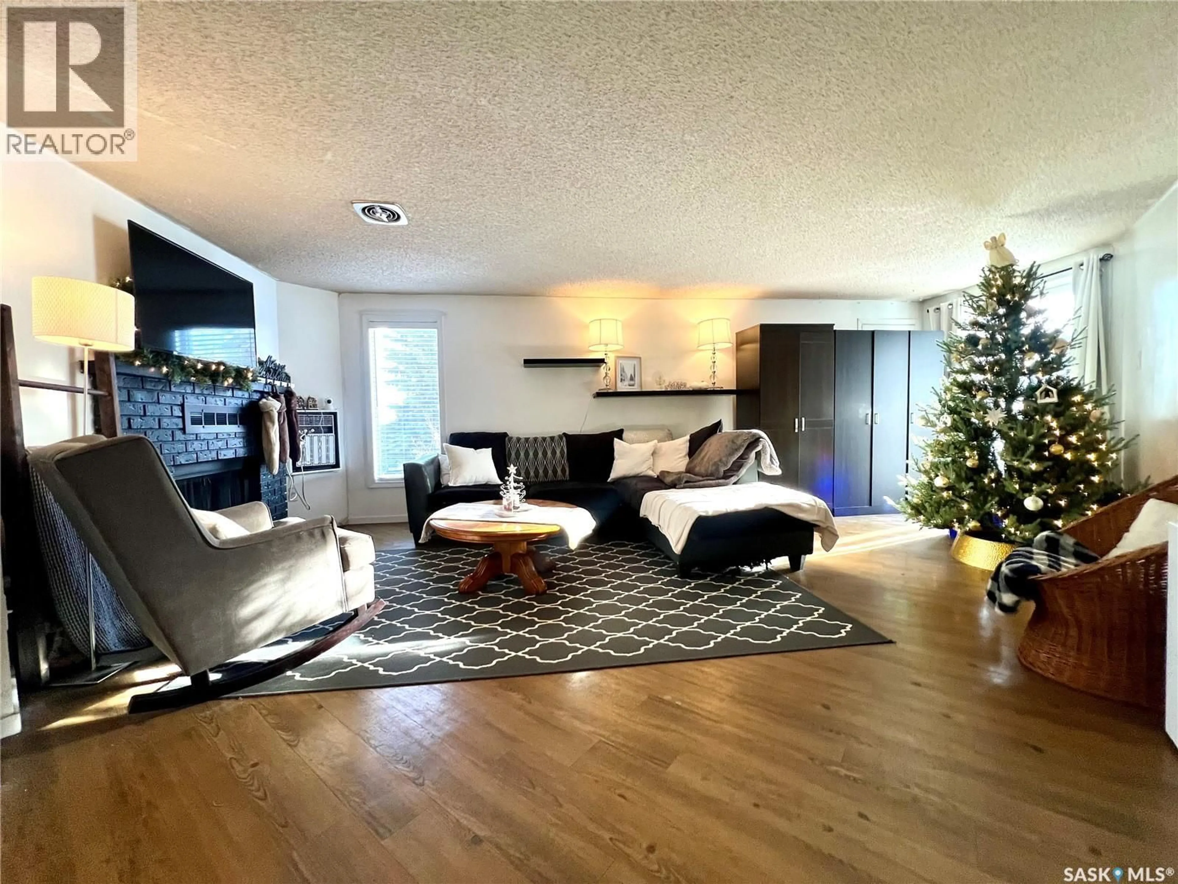 Living room with furniture, wood/laminate floor for 202 306 TAIT CRESCENT, Saskatoon Saskatchewan S7H5L2
