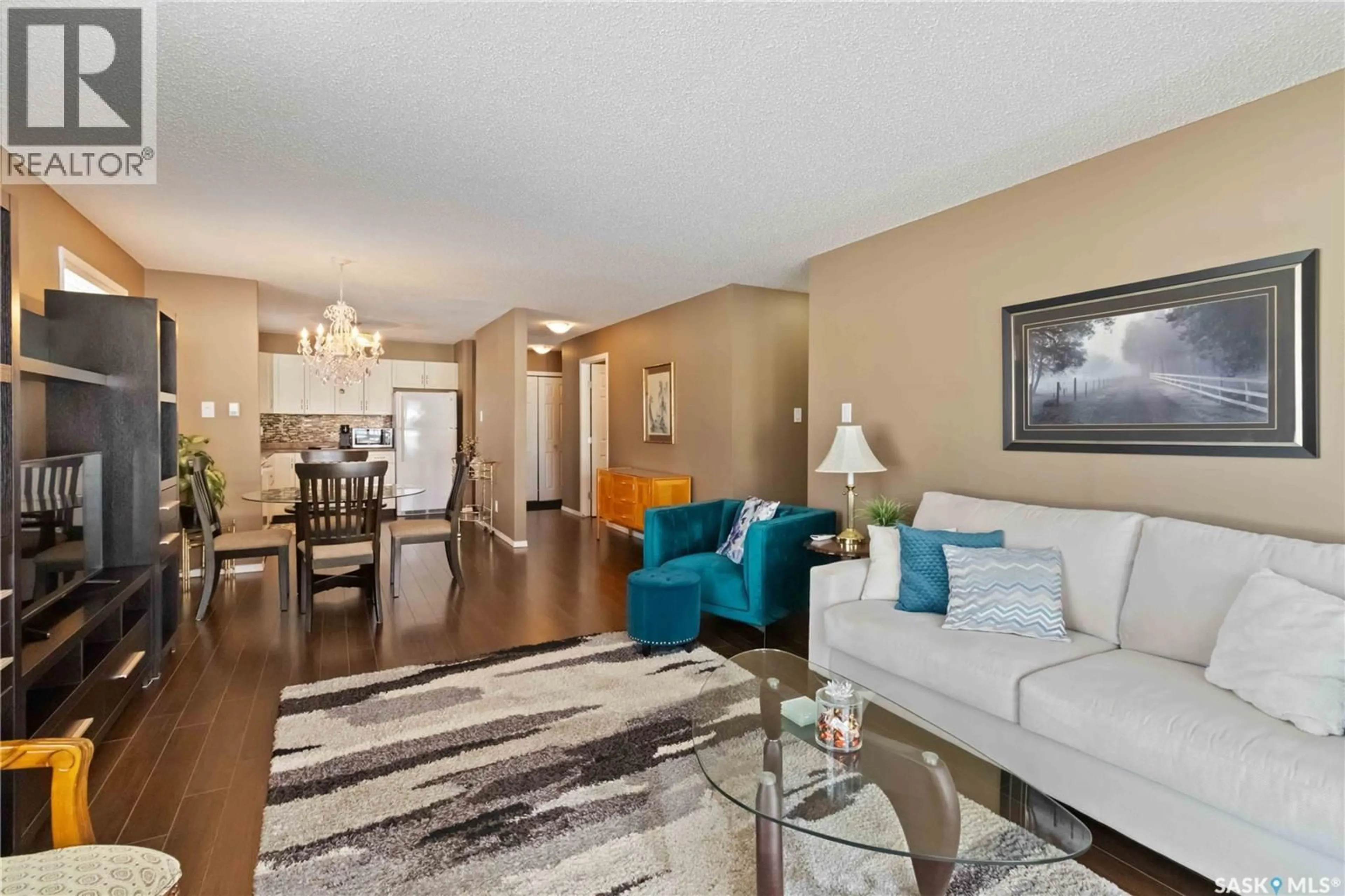 Living room with furniture, wood/laminate floor for 706 - 112 CONFEDERATION DRIVE, Saskatoon Saskatchewan S7L5R7