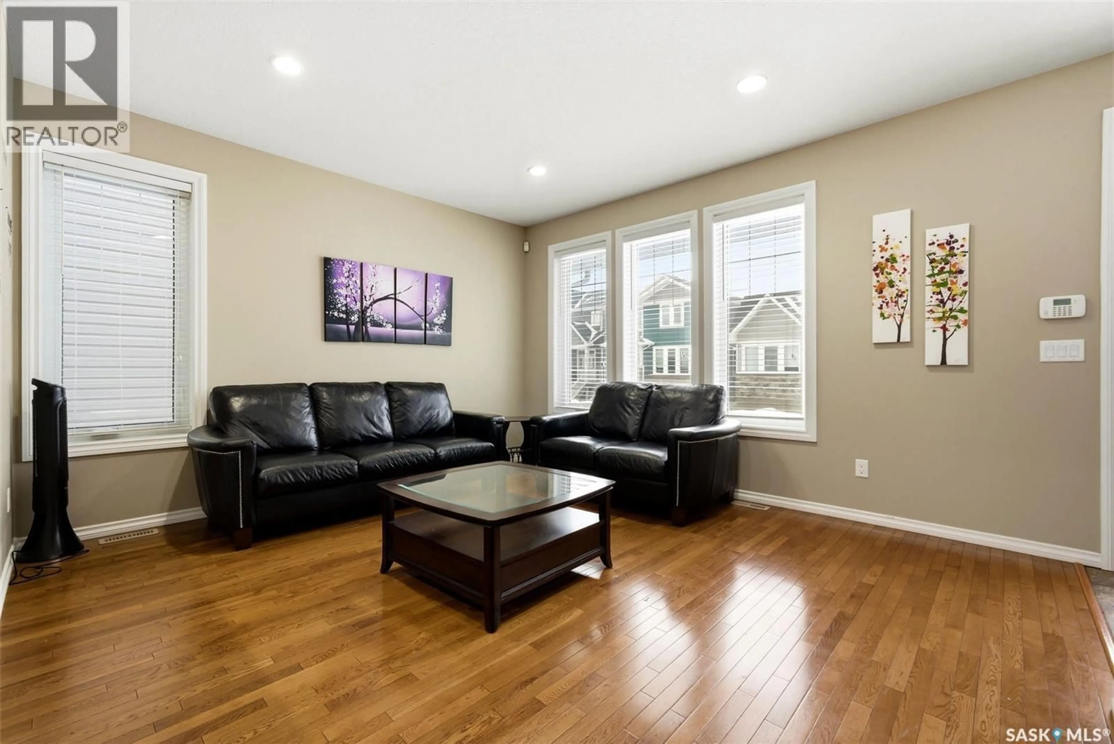 Living room with furniture, wood/laminate floor for 1122 JURASIN STREET, Regina Saskatchewan S4X0K1
