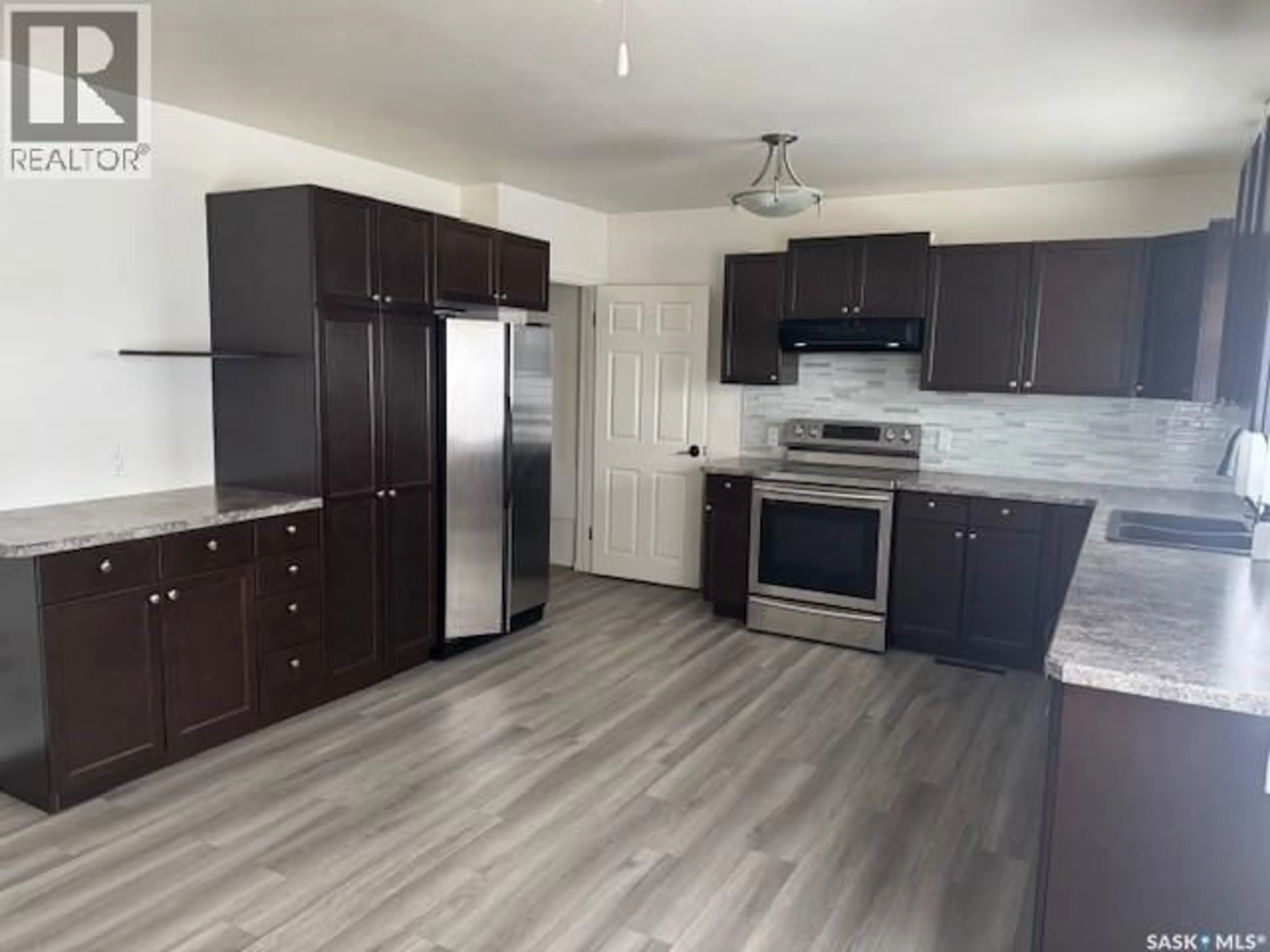 Open concept kitchen, wood/laminate floor for 2 22ND STREET, Battleford Saskatchewan S0M0E0