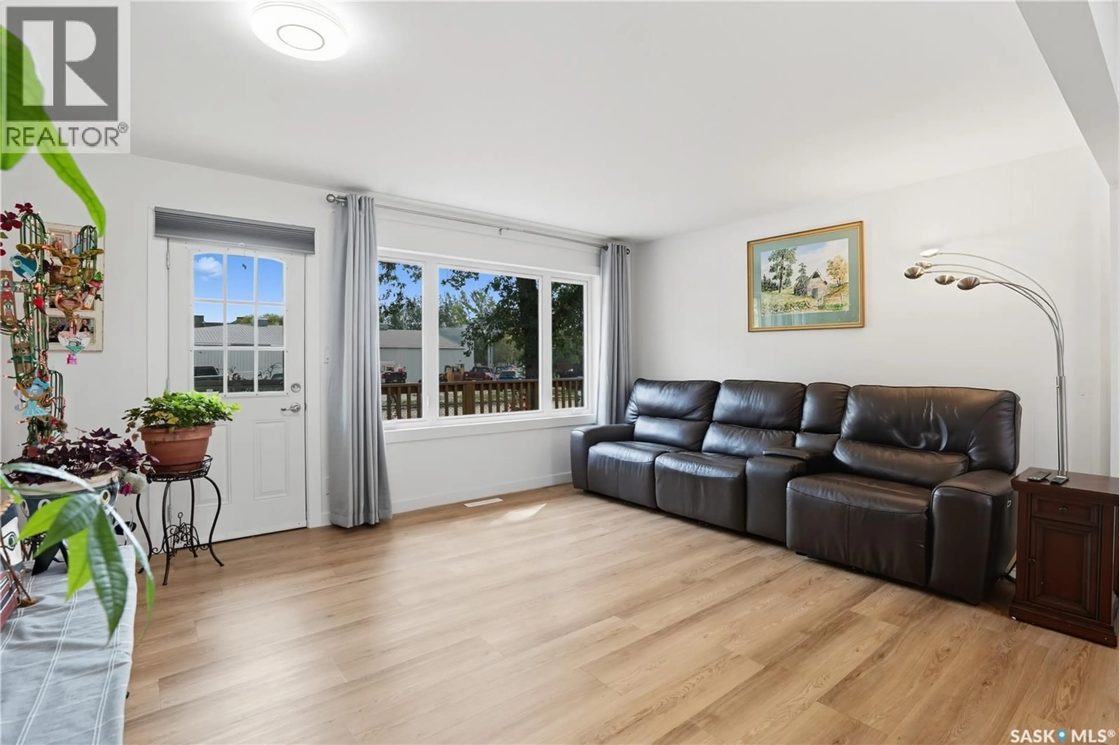 Living room with furniture, wood/laminate floor for 16 WALSH STREET, Qu'Appelle Saskatchewan S0G4A0