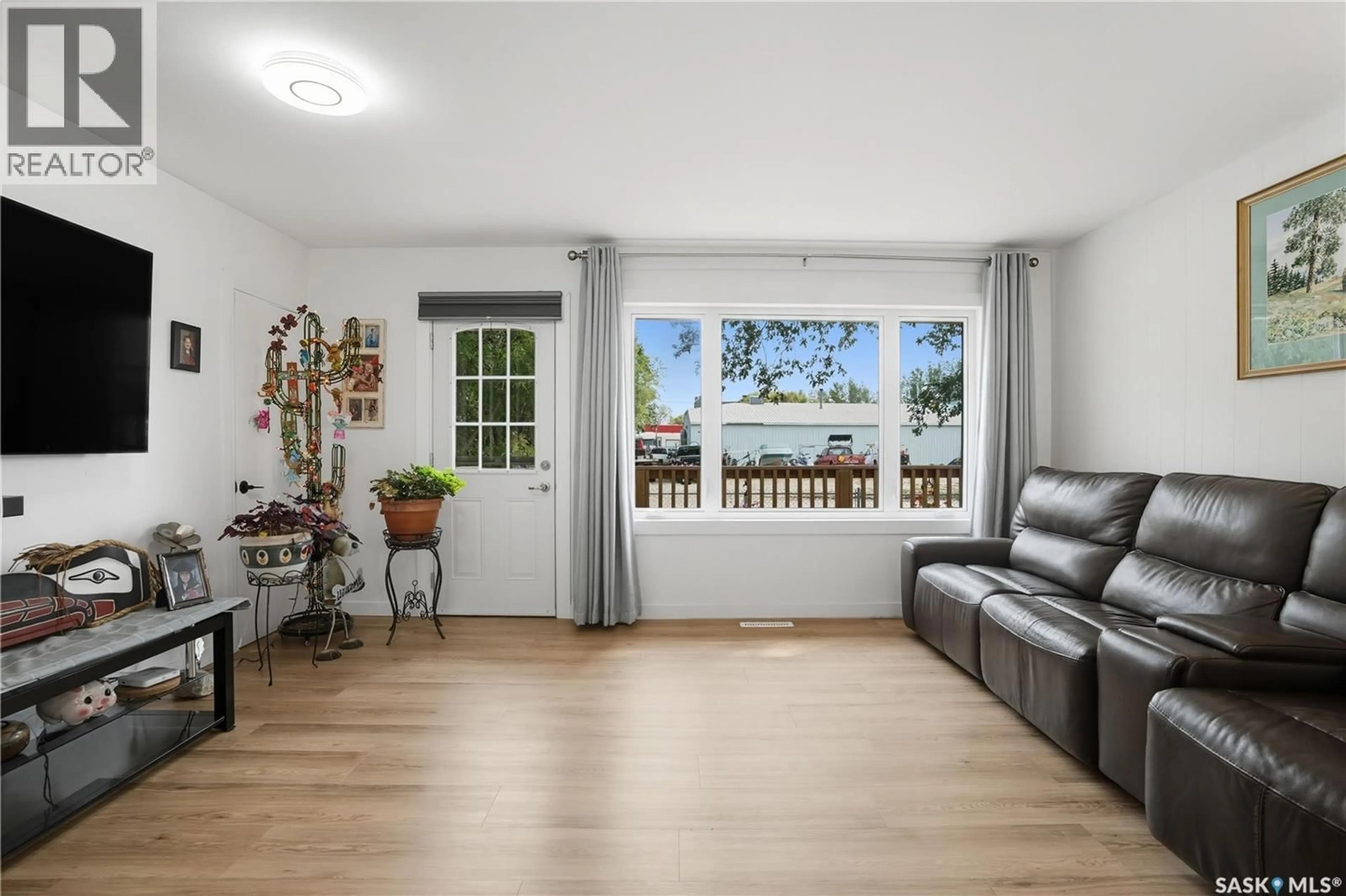 Living room with furniture, wood/laminate floor for 16 WALSH STREET, Qu'Appelle Saskatchewan S0G4A0