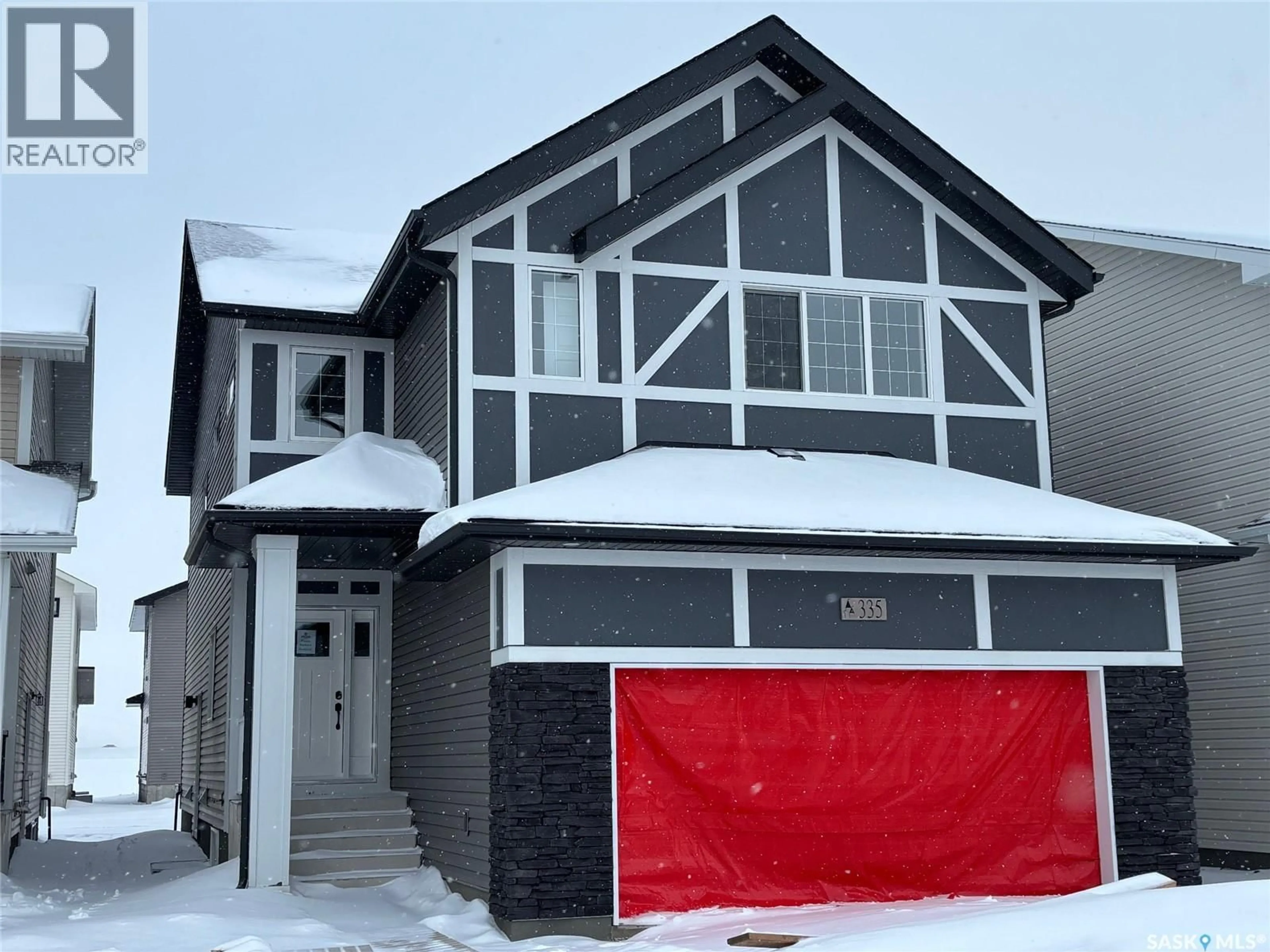 Home with vinyl exterior material, street for 335 ASOKAN BEND, Saskatoon Saskatchewan S7V1V7