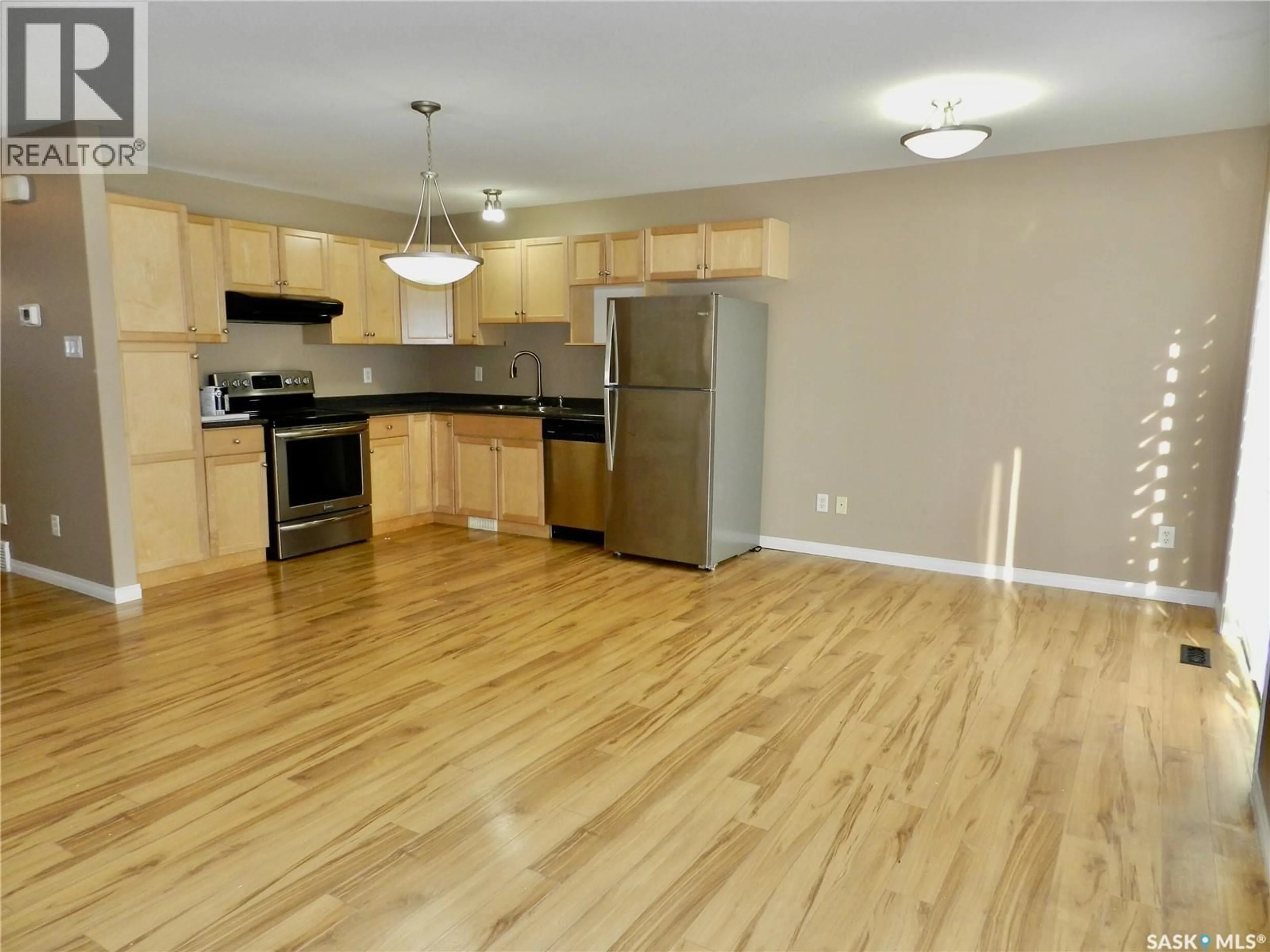 Open concept kitchen, wood/laminate floor for 851 - 218 CHESTER ROAD, Moose Jaw Saskatchewan S6J0A4
