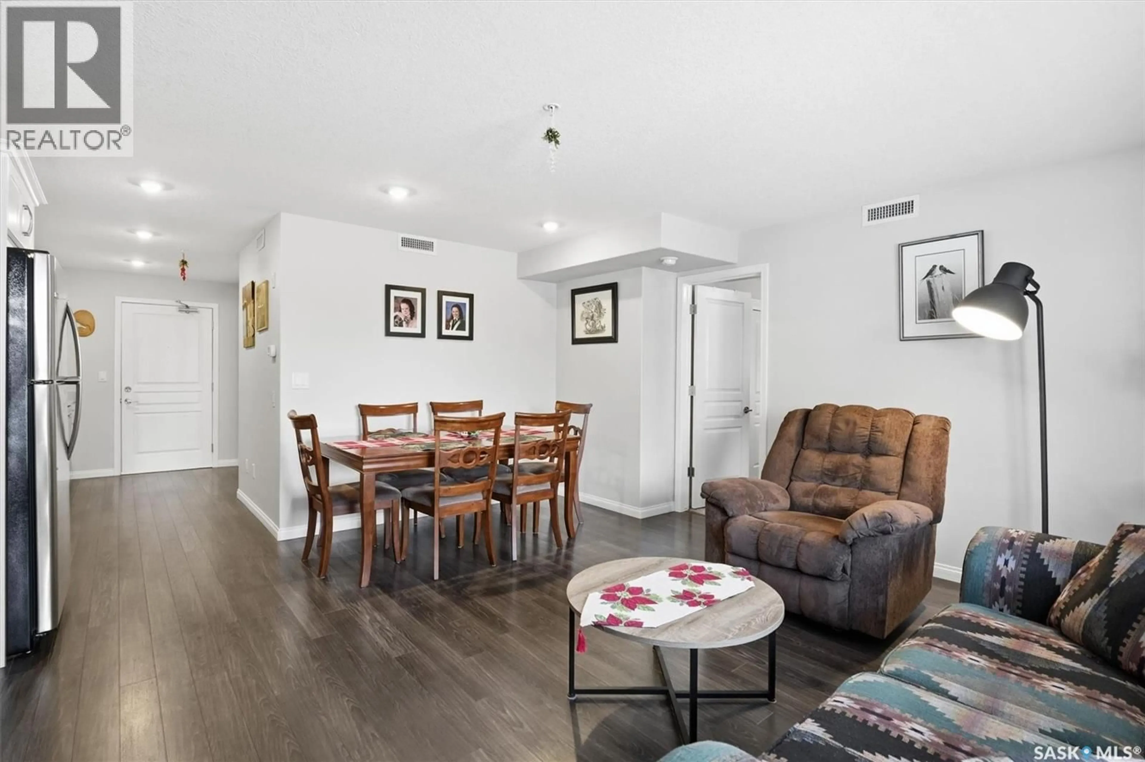 Living room with furniture, wood/laminate floor for 106 - 3106 WILLIS CRESCENT, Saskatoon Saskatchewan S7T0Y6