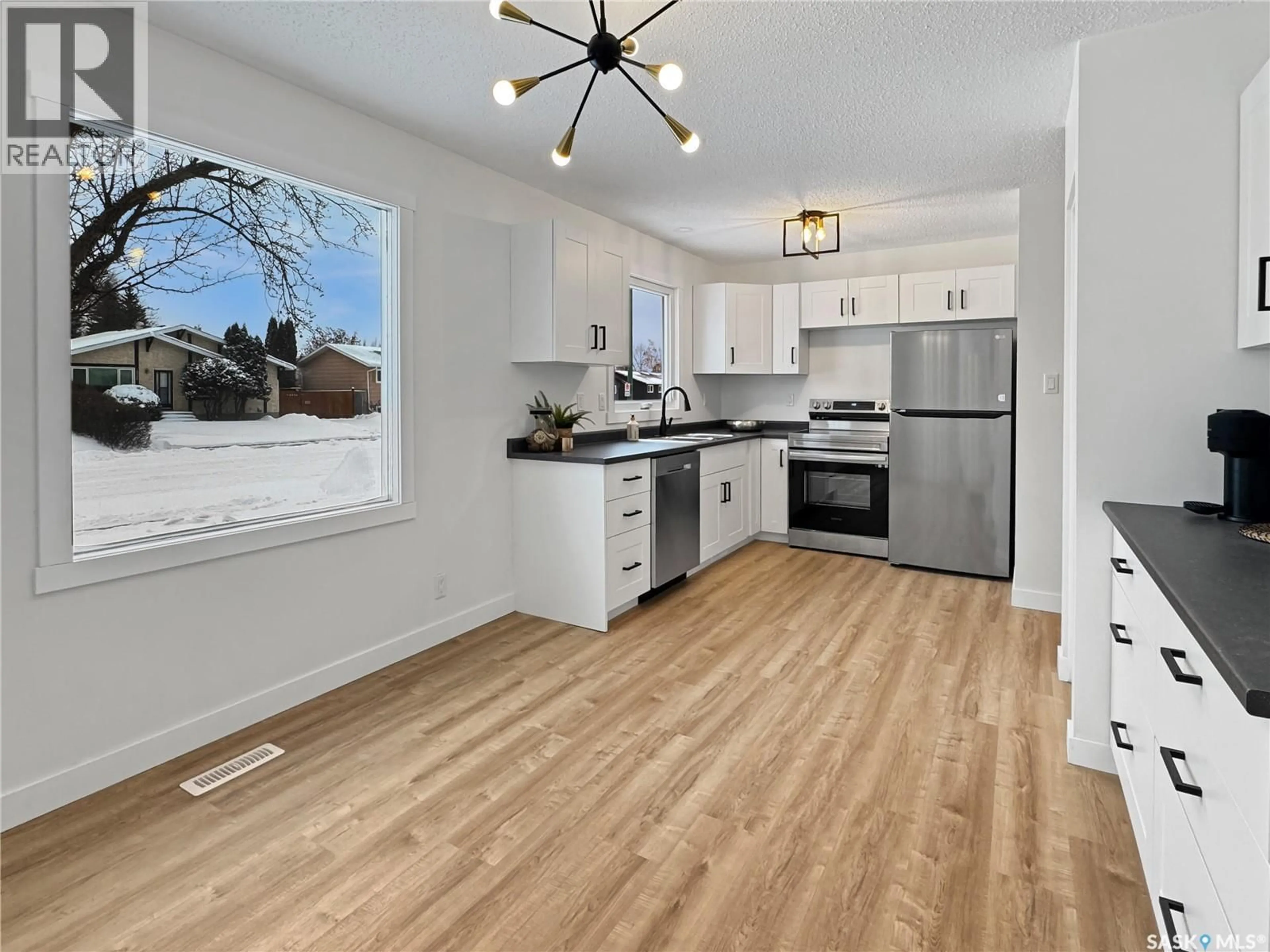 Open concept kitchen, wood/laminate floor for 10929 SCOTT DRIVE, North Battleford Saskatchewan S9A3N2