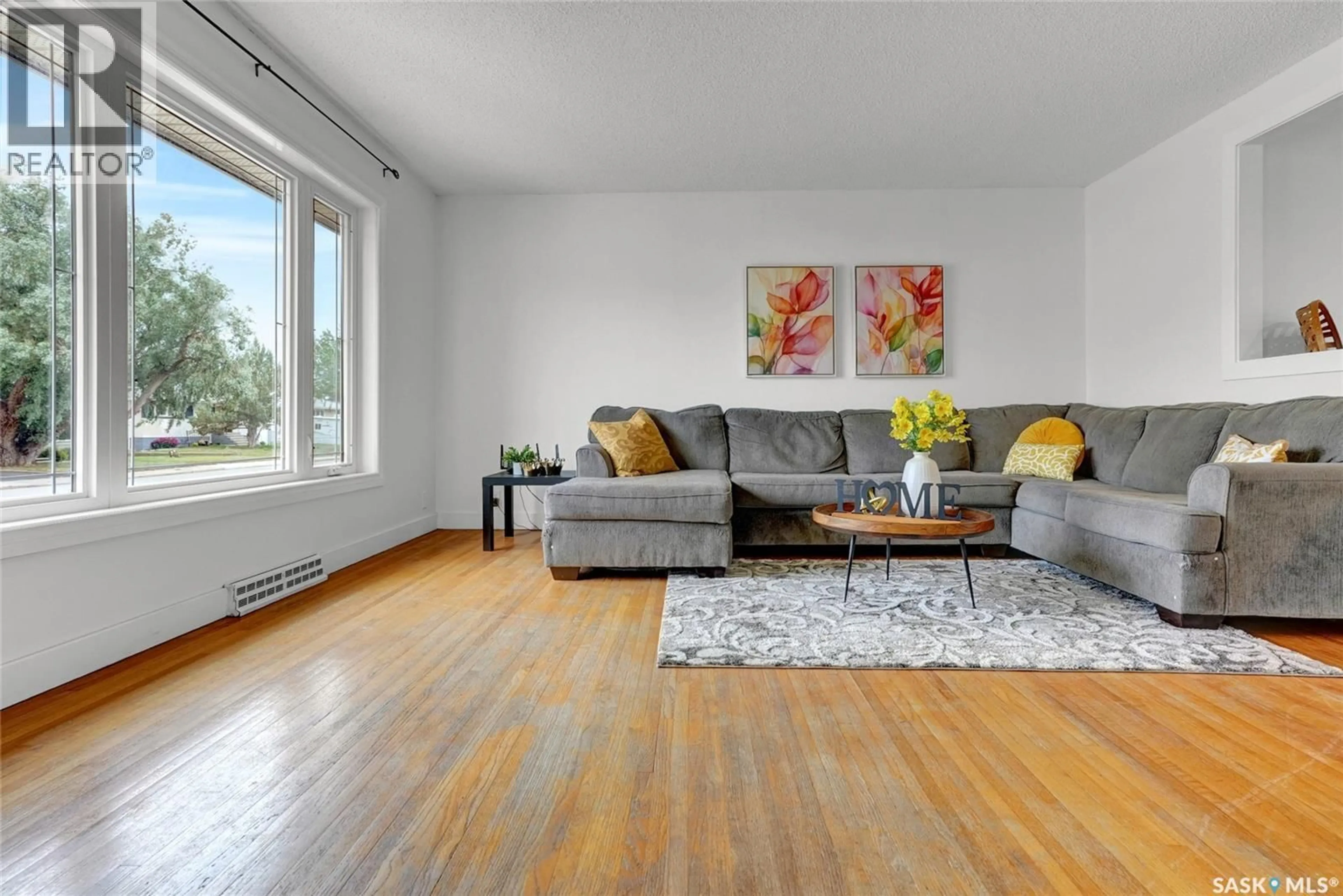 Living room with furniture, wood/laminate floor for 833 KEITH STREET, Moose Jaw Saskatchewan S6H5R4