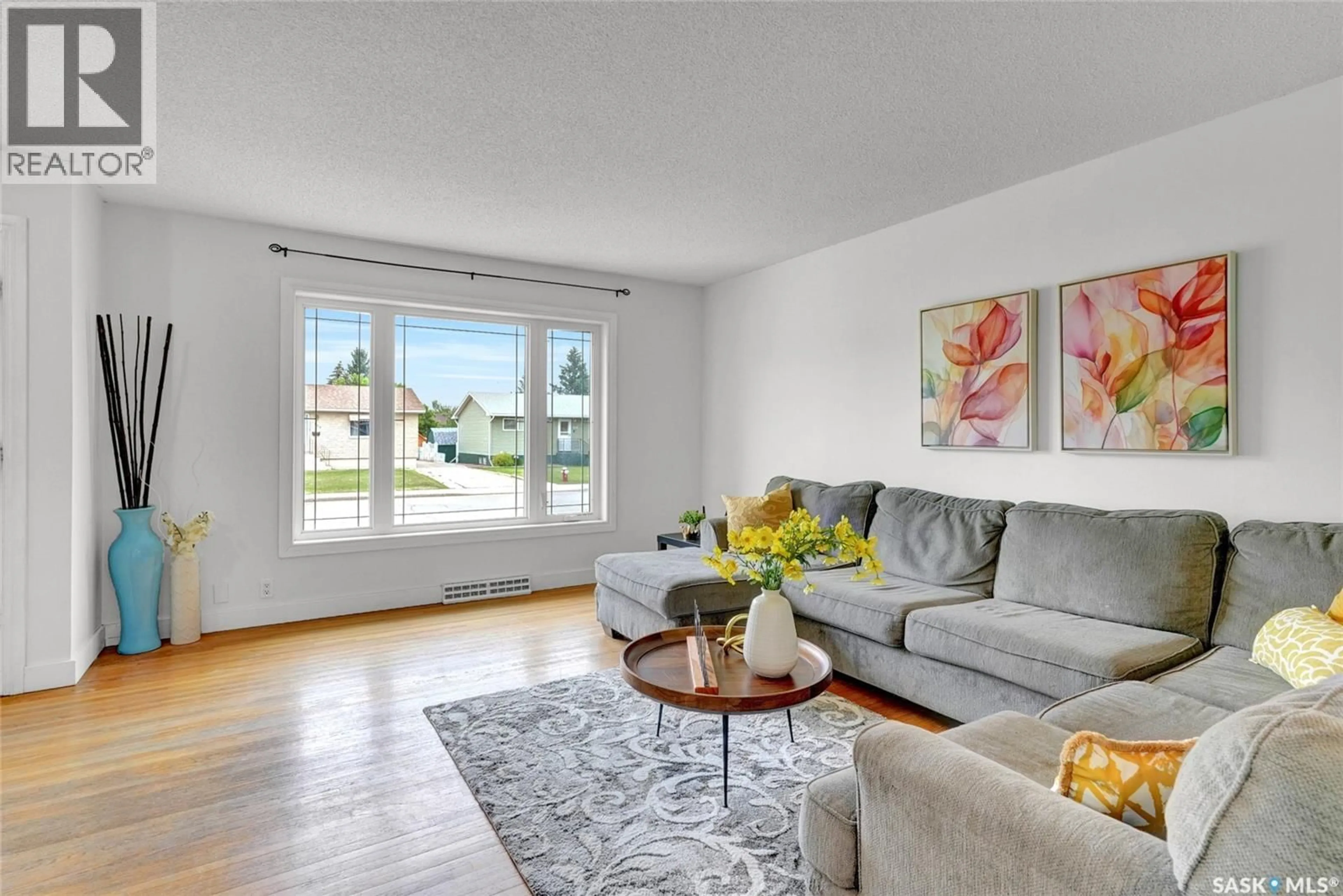 Living room with furniture, wood/laminate floor for 833 KEITH STREET, Moose Jaw Saskatchewan S6H5R4