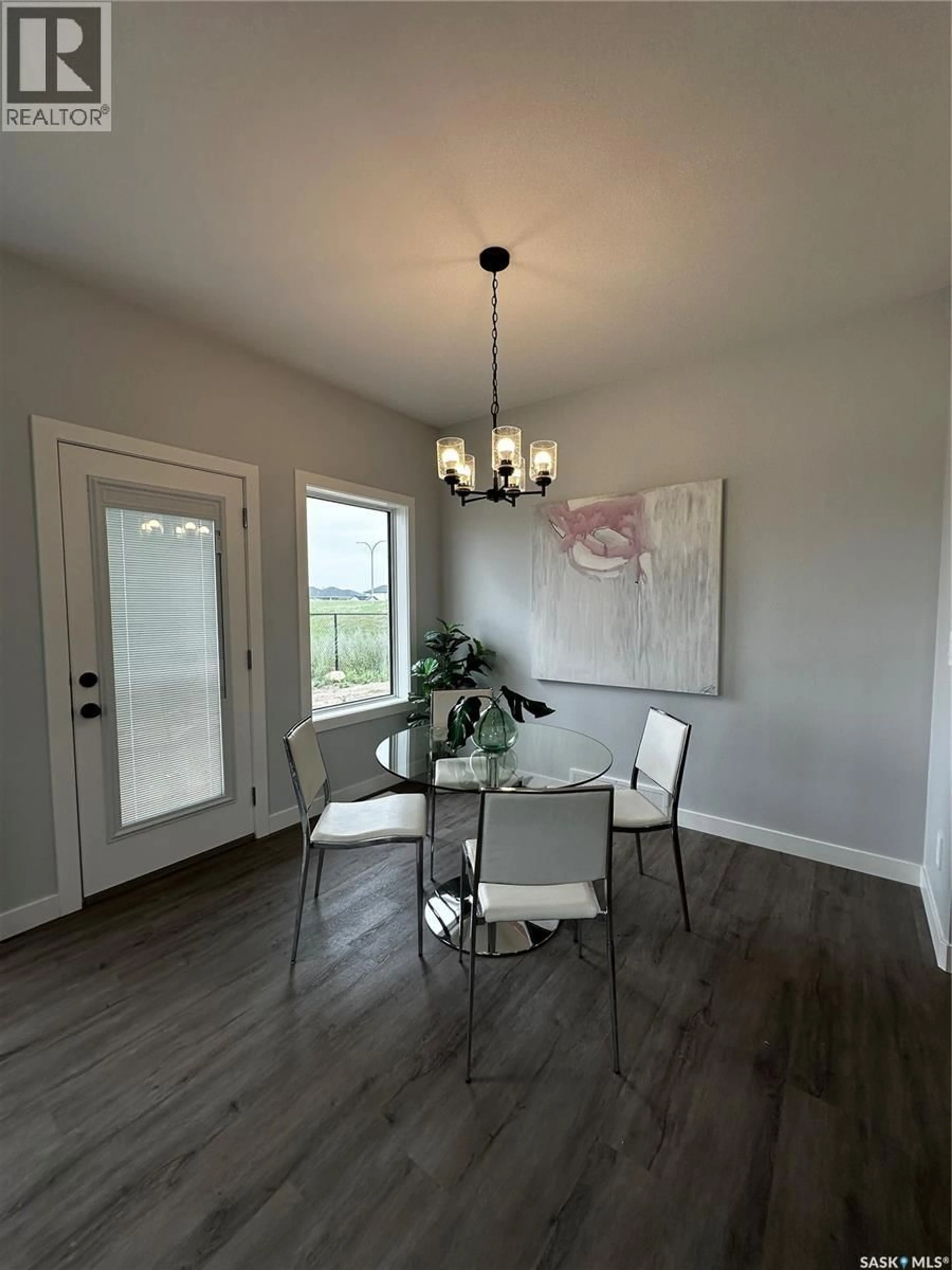 Dining room, wood/laminate floor for 522 MYLES HEIDT MANOR, Saskatoon Saskatchewan S7W0Z4
