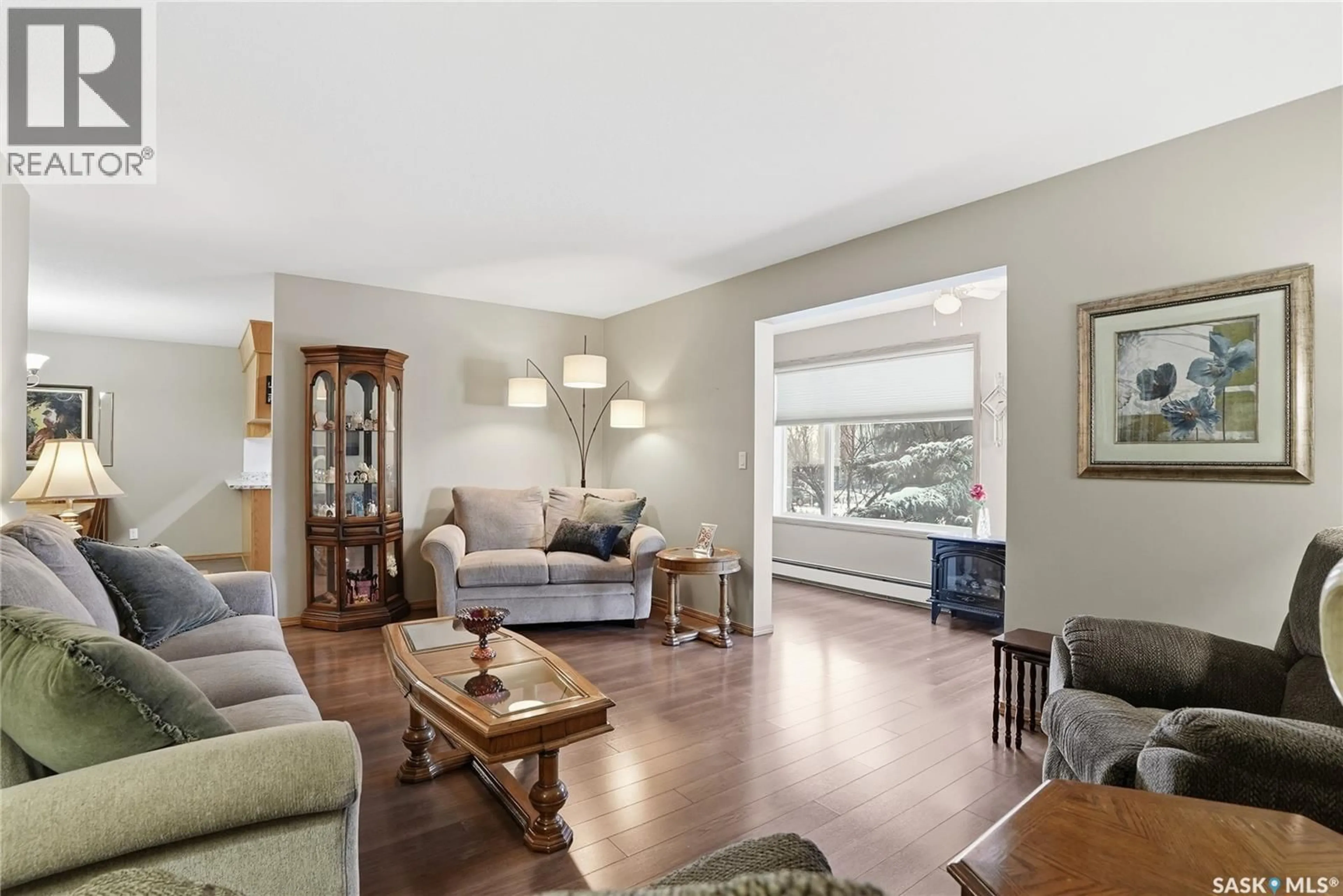 Living room with furniture, wood/laminate floor for 111 103 KEEVIL CRESCENT, Saskatoon Saskatchewan S7N4L9