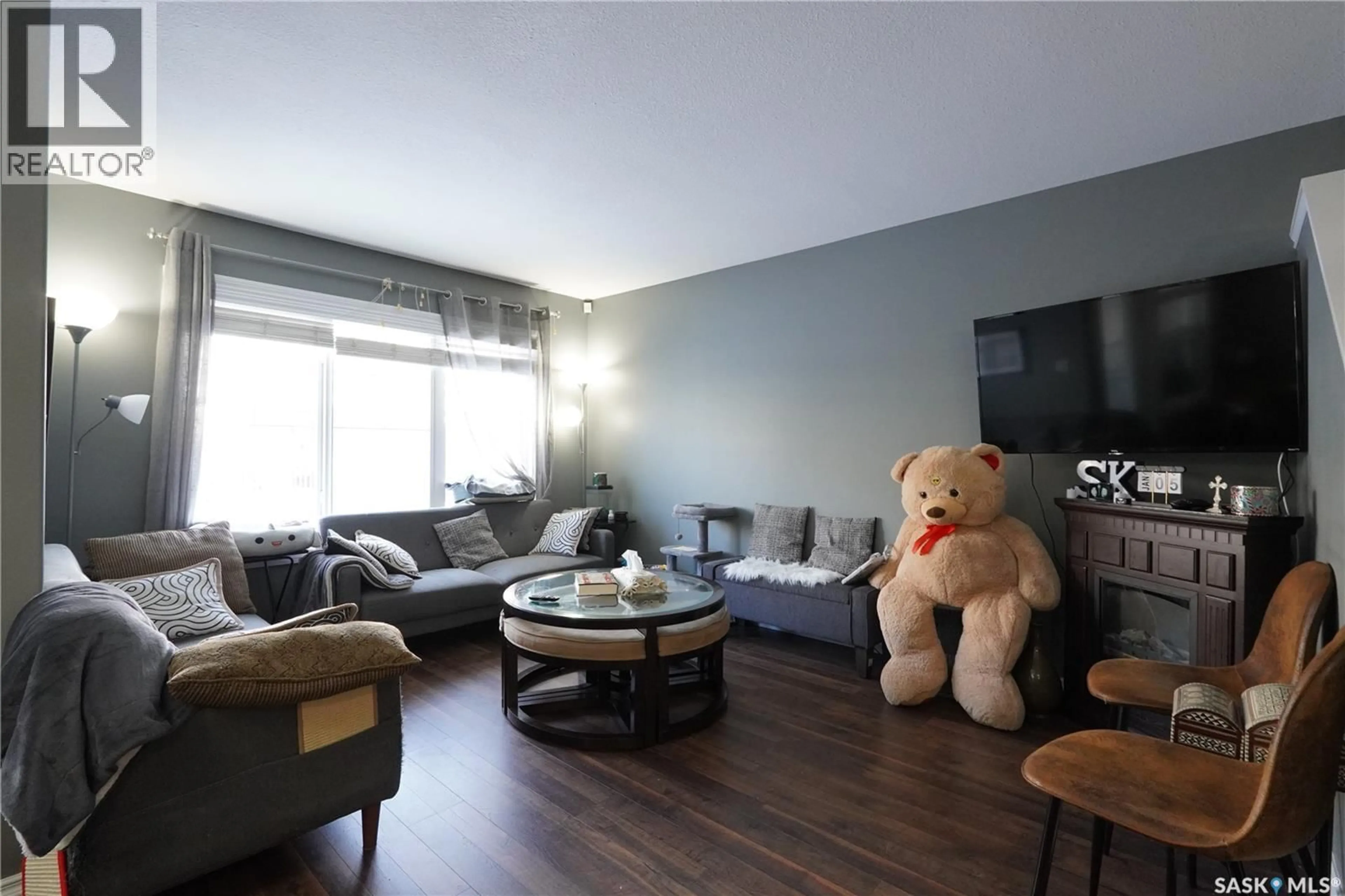 Living room with furniture, wood/laminate floor for 4514 HARBOUR VILLAGE WAY, Regina Saskatchewan S4W0C1