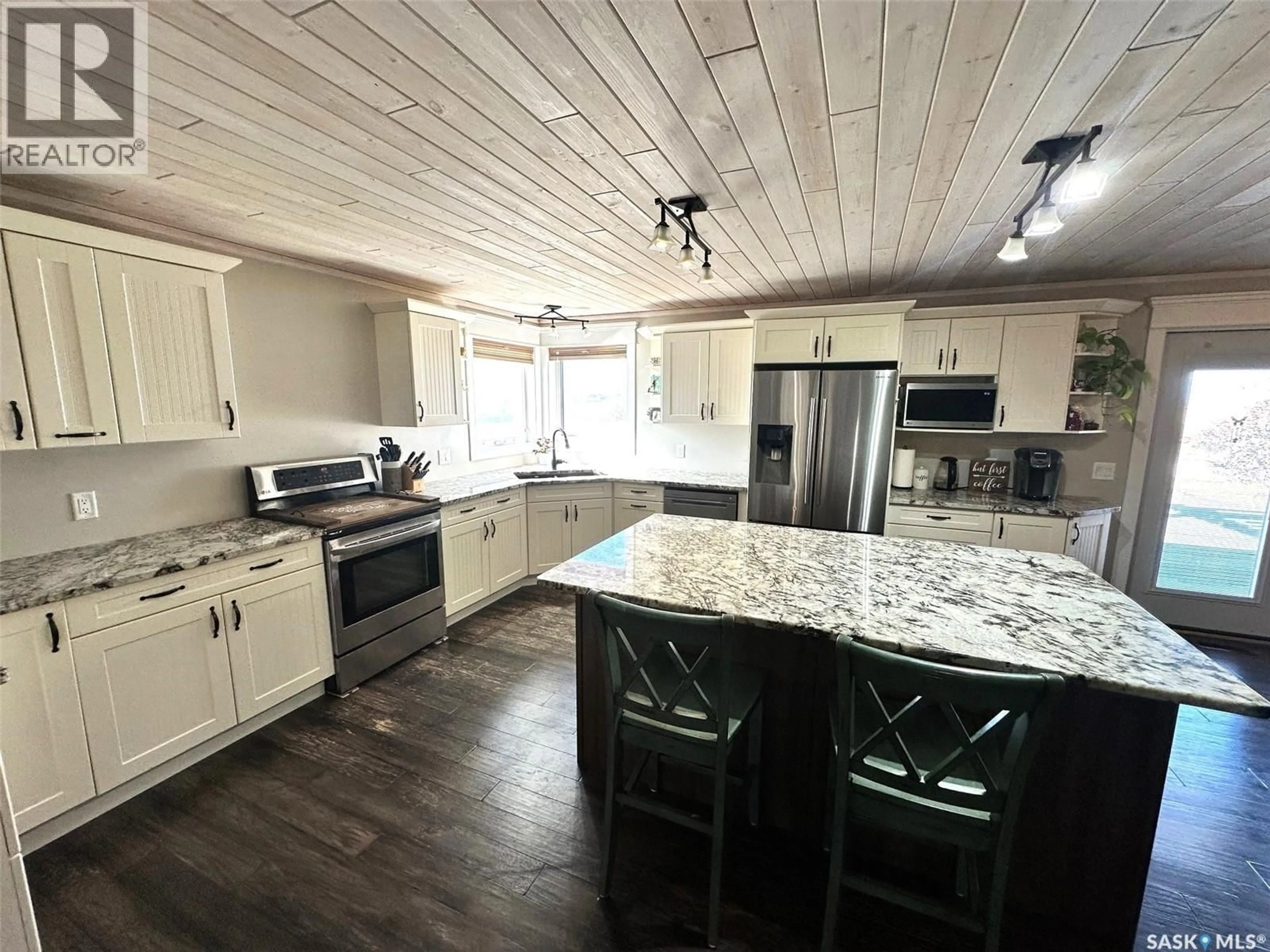Open concept kitchen, wood/laminate floor for ZURBA ACREAGE, Hudson Bay Rm No. 394 Saskatchewan S0E0Y0