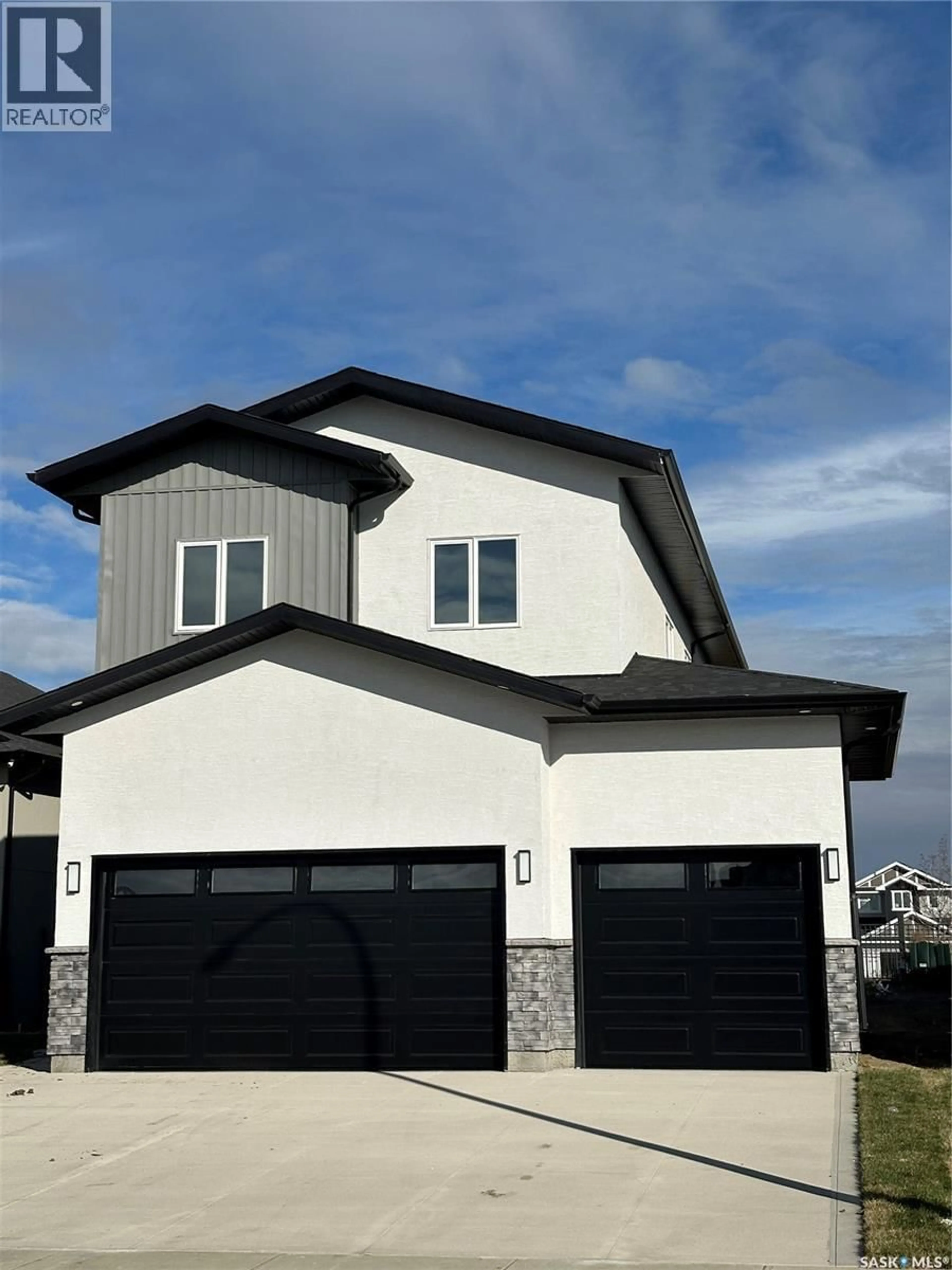 Home with vinyl exterior material, street for 147 WOOLF BEND, Saskatoon Saskatchewan S7W0L6