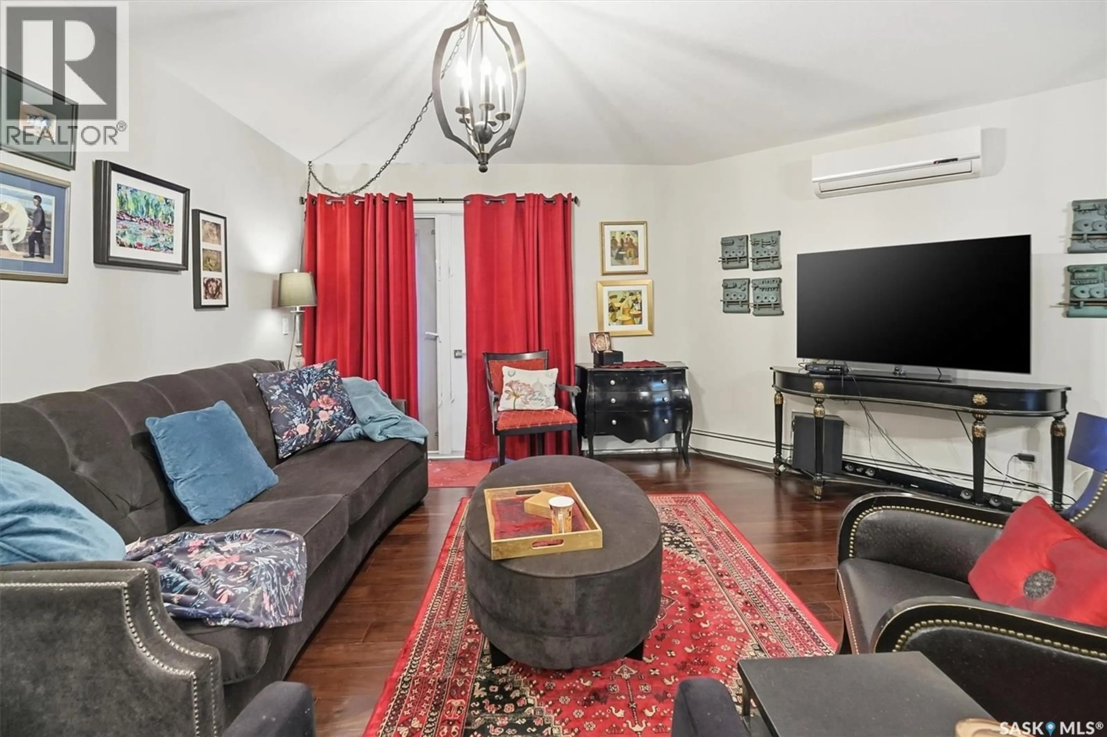 Living room with furniture, wood/laminate floor for 112 130 PHELPS WAY, Saskatoon Saskatchewan S7V0K5