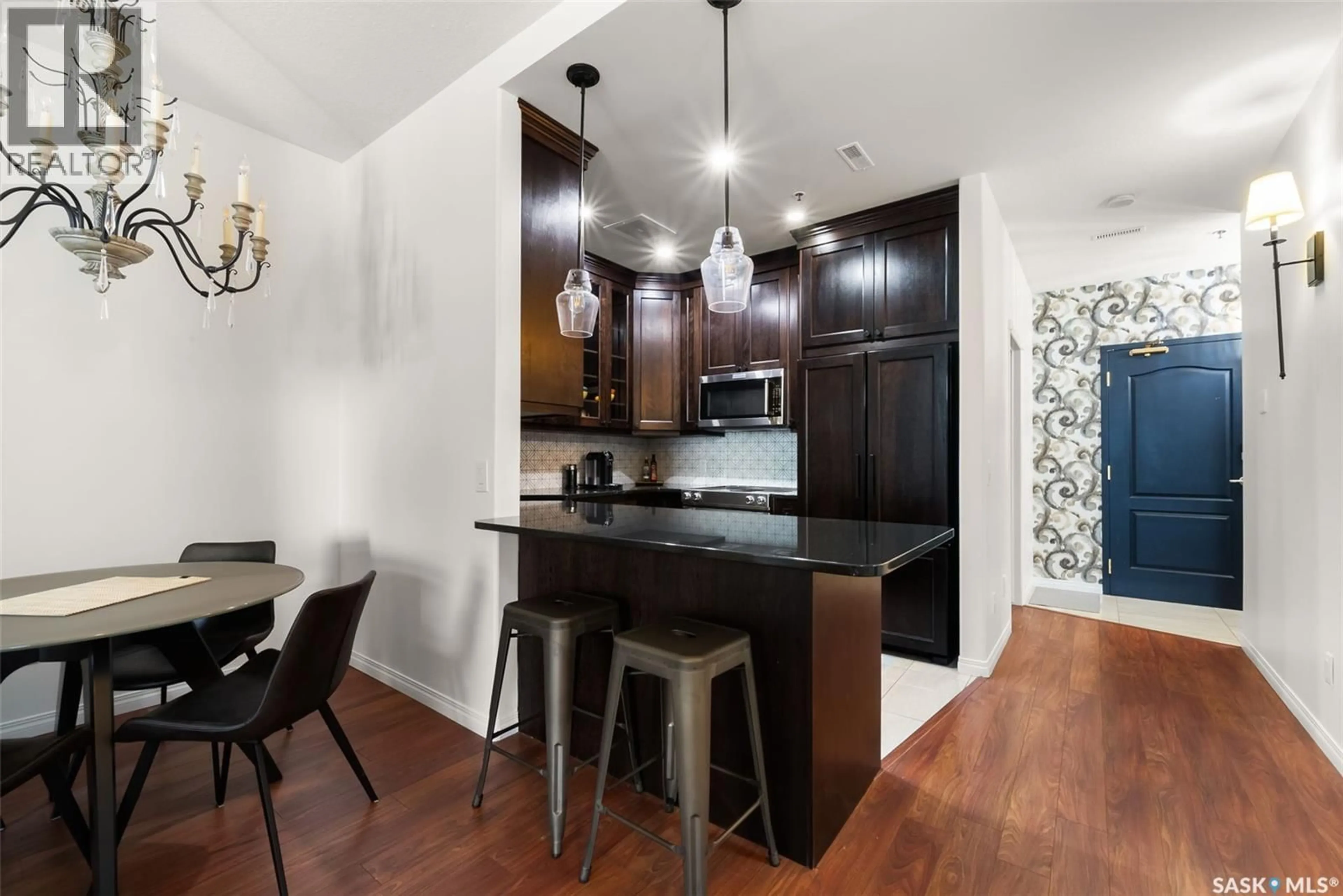 Open concept kitchen, wood/laminate floor for 703 1901 VICTORIA AVENUE, Regina Saskatchewan S4P3R4