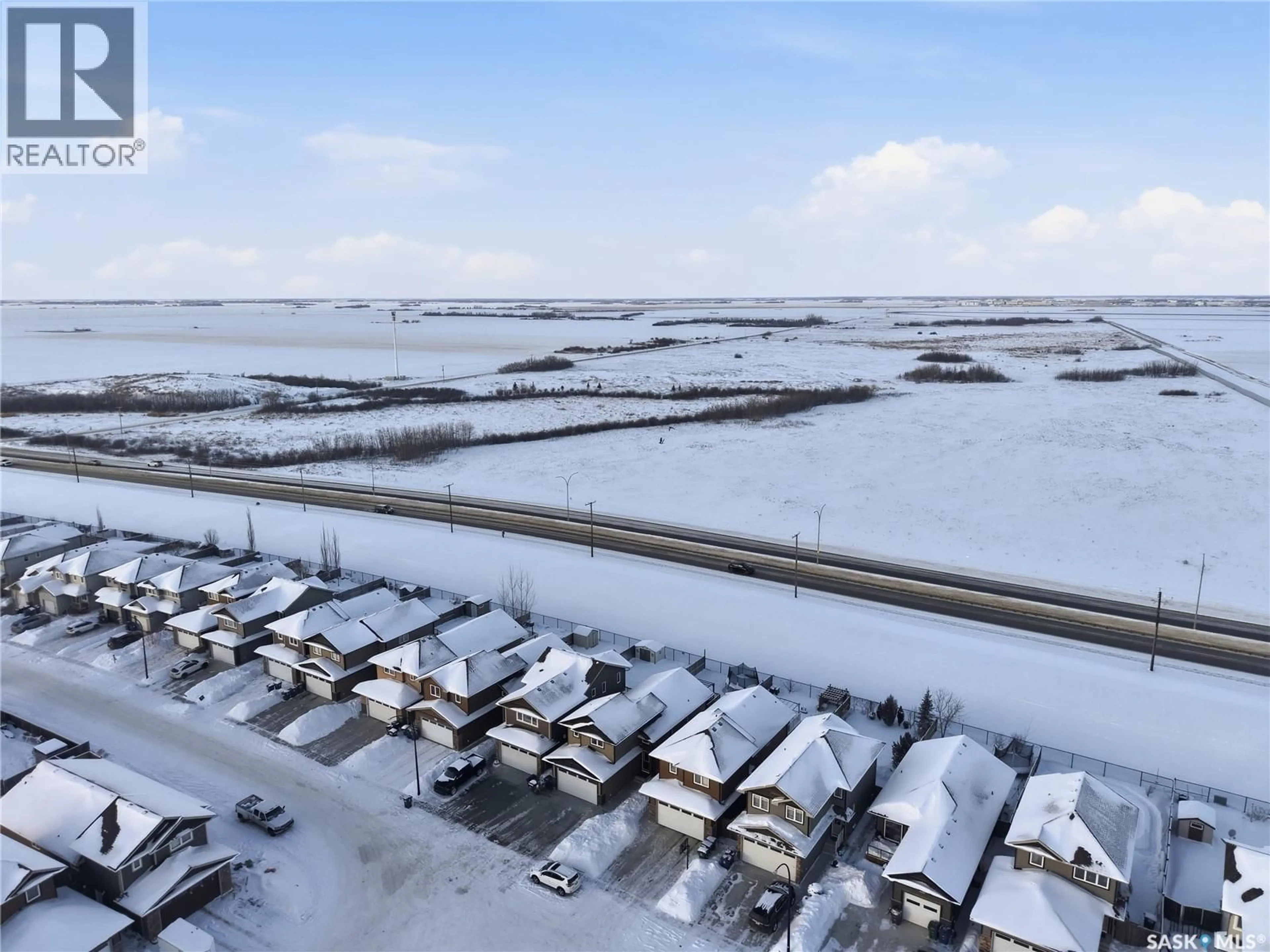 A pic from outside/outdoor area/front of a property/back of a property/a pic from drone, street for 219 HENICK CRESCENT, Saskatoon Saskatchewan S7H0J9