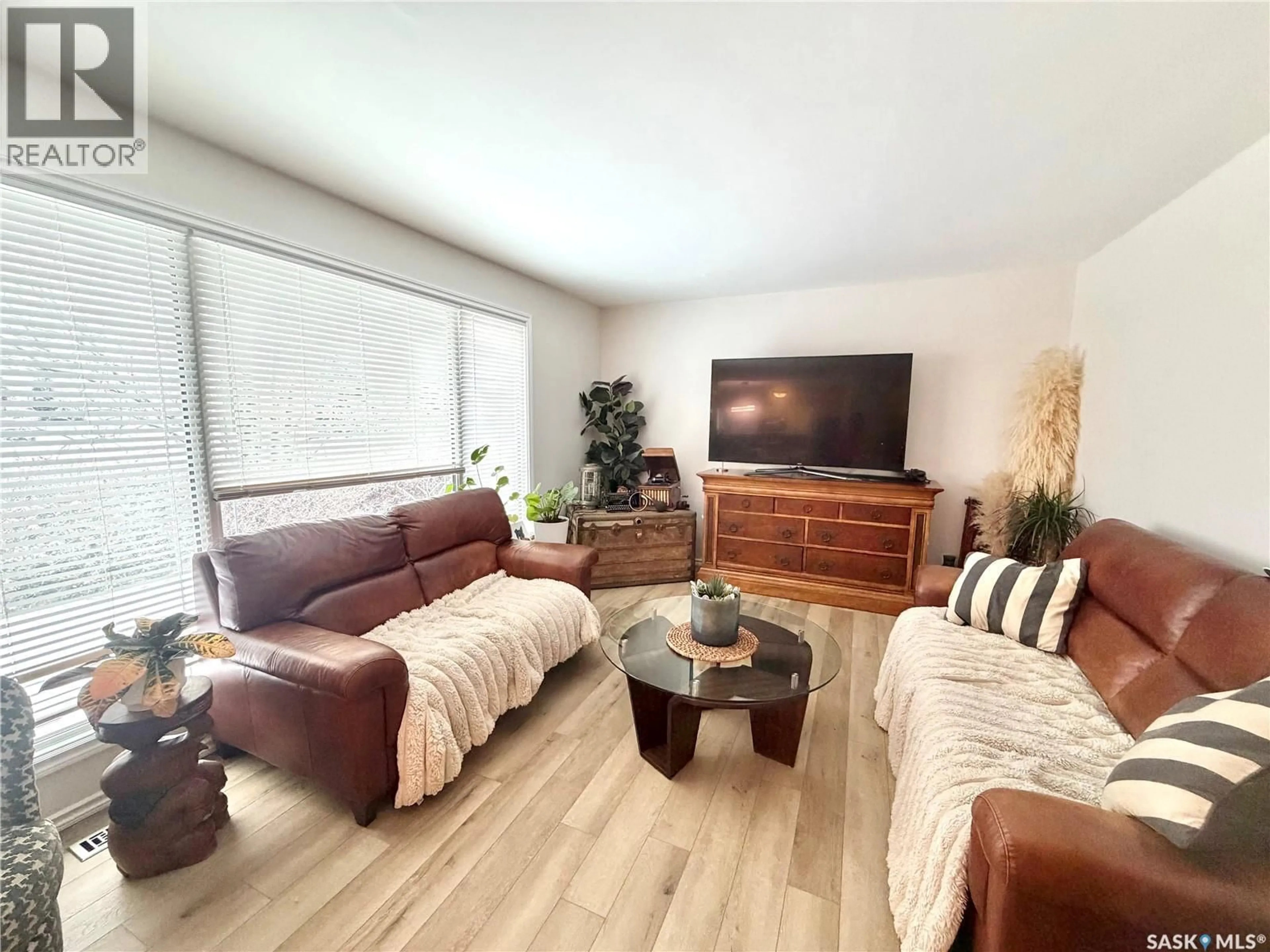Living room with furniture, wood/laminate floor for 202 19TH STREET, Battleford Saskatchewan S0M0E0