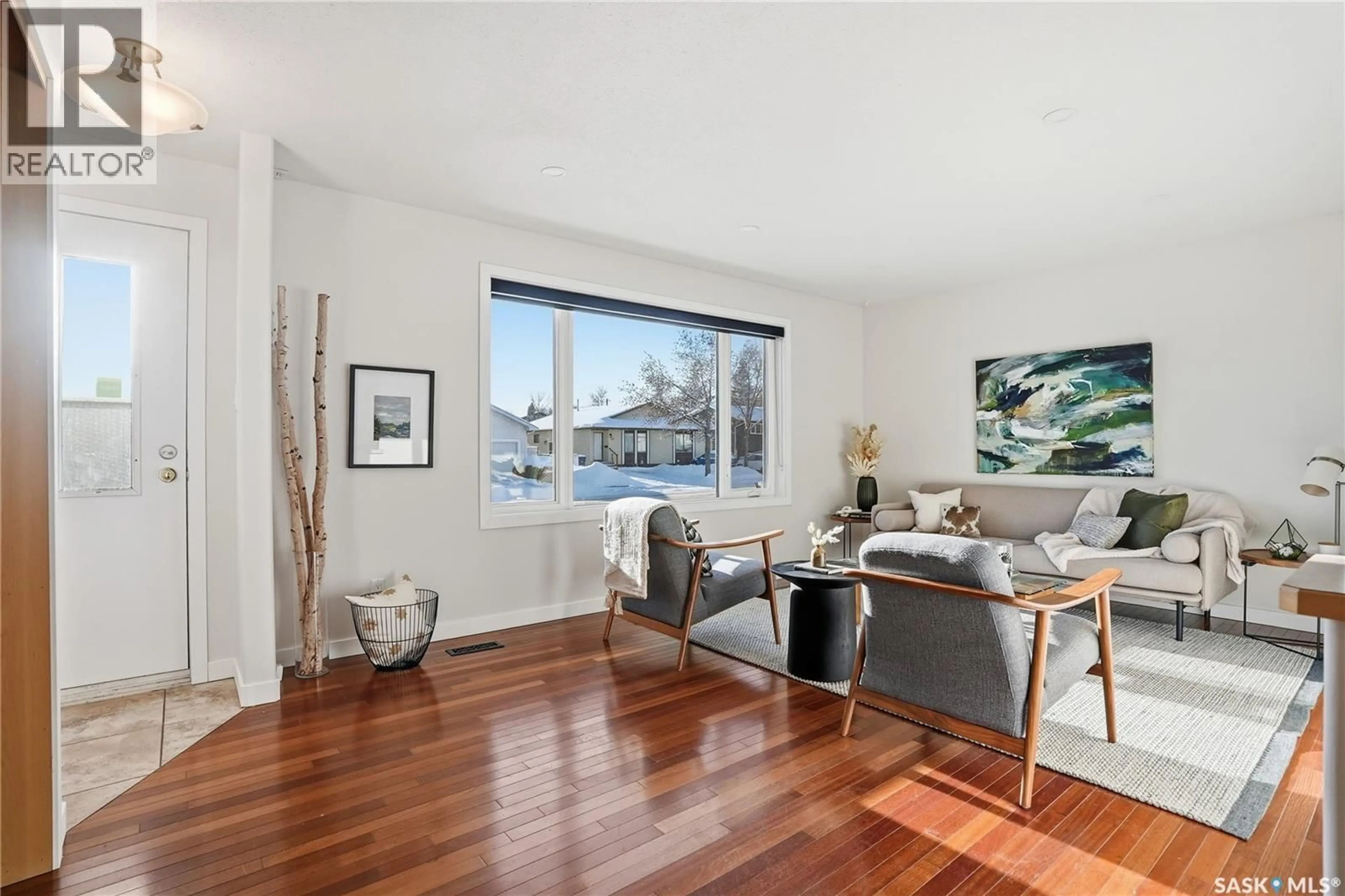 Living room with furniture, wood/laminate floor for 218 WEDGE ROAD, Saskatoon Saskatchewan S7L6E9