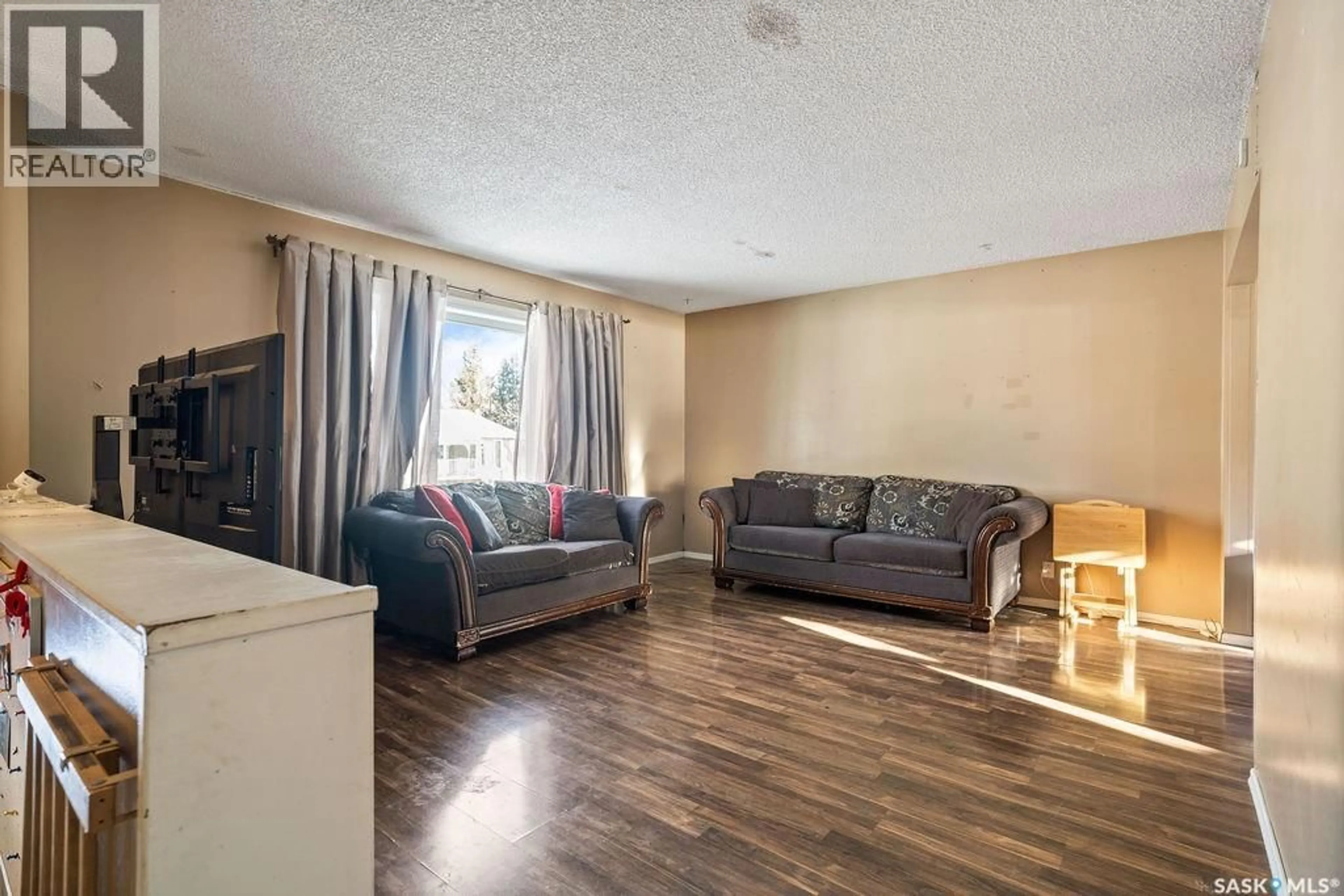 Living room with furniture, wood/laminate floor for 50 HYLAND CRESCENT, Regina Saskatchewan S4R7P3