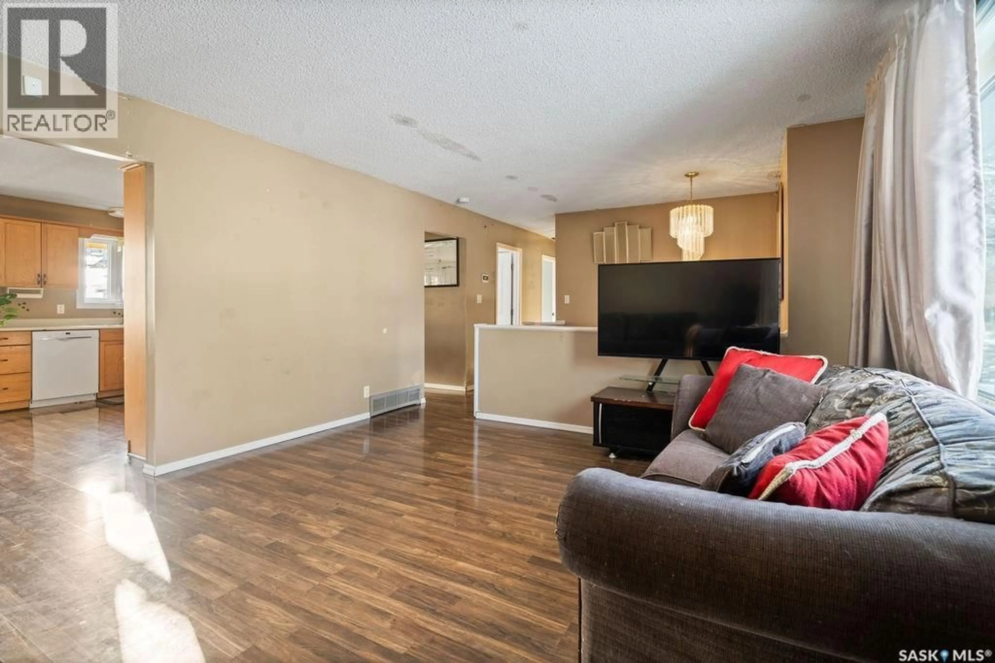Living room with furniture, wood/laminate floor for 50 HYLAND CRESCENT, Regina Saskatchewan S4R7P3