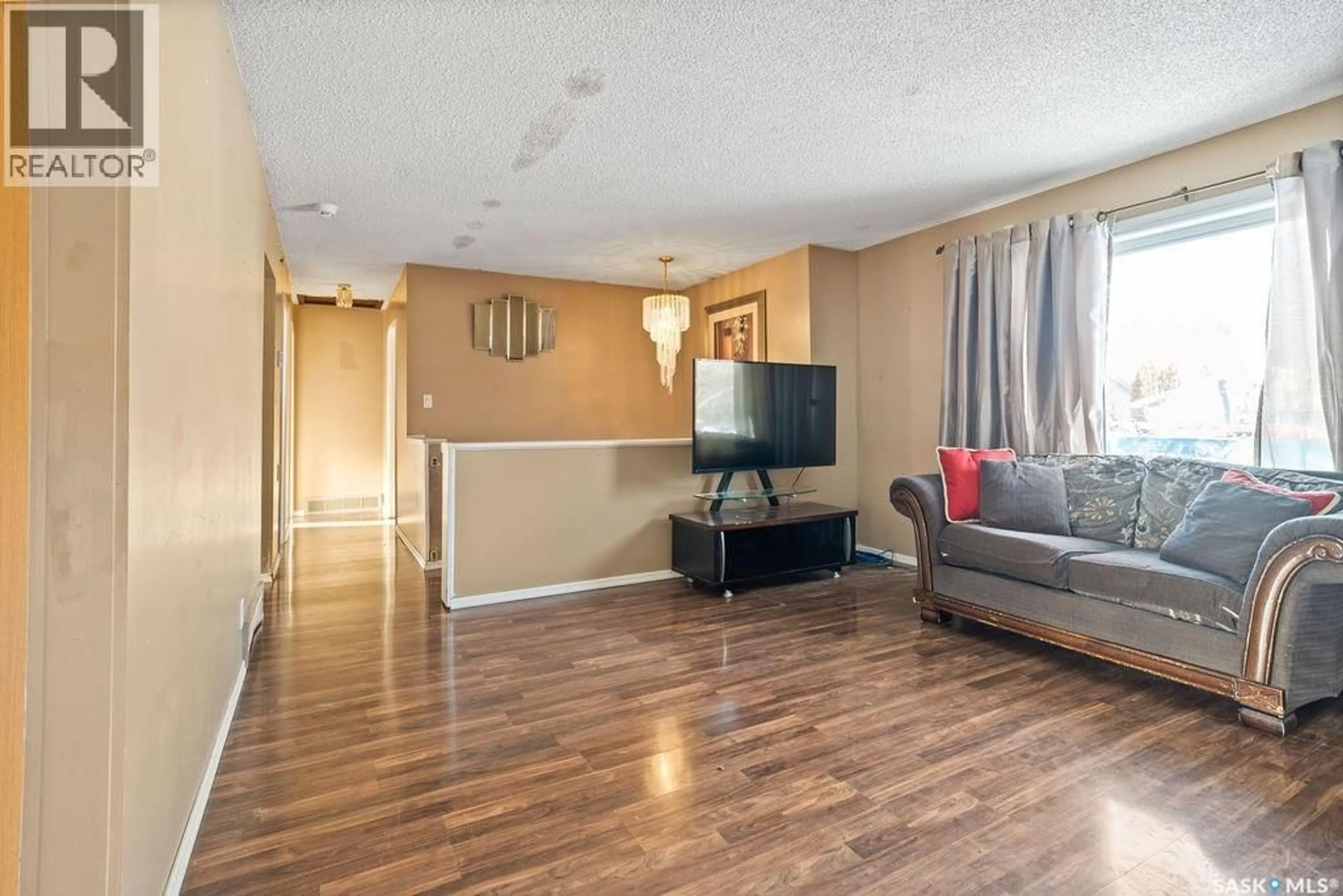 Living room with furniture, wood/laminate floor for 50 HYLAND CRESCENT, Regina Saskatchewan S4R7P3