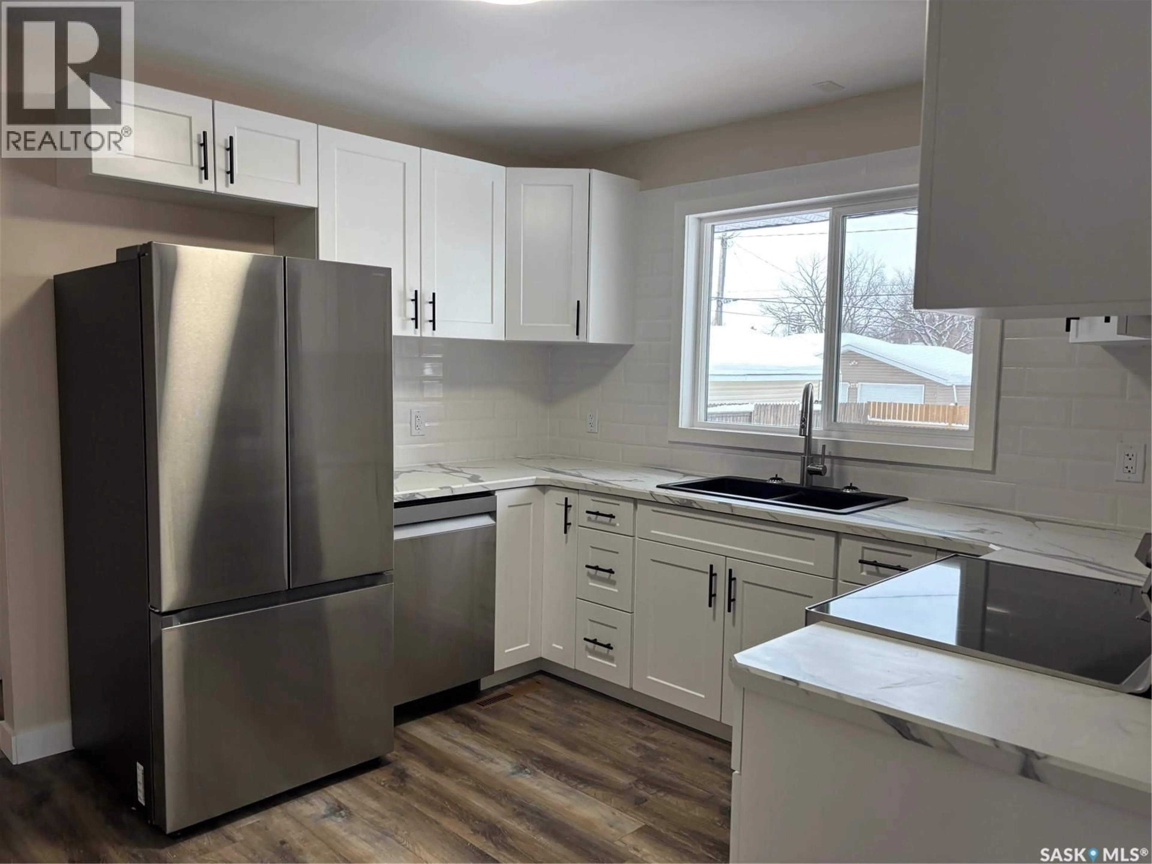 Open concept kitchen, wood/laminate floor for 353 25TH STREET, Prince Albert Saskatchewan S6V4P5