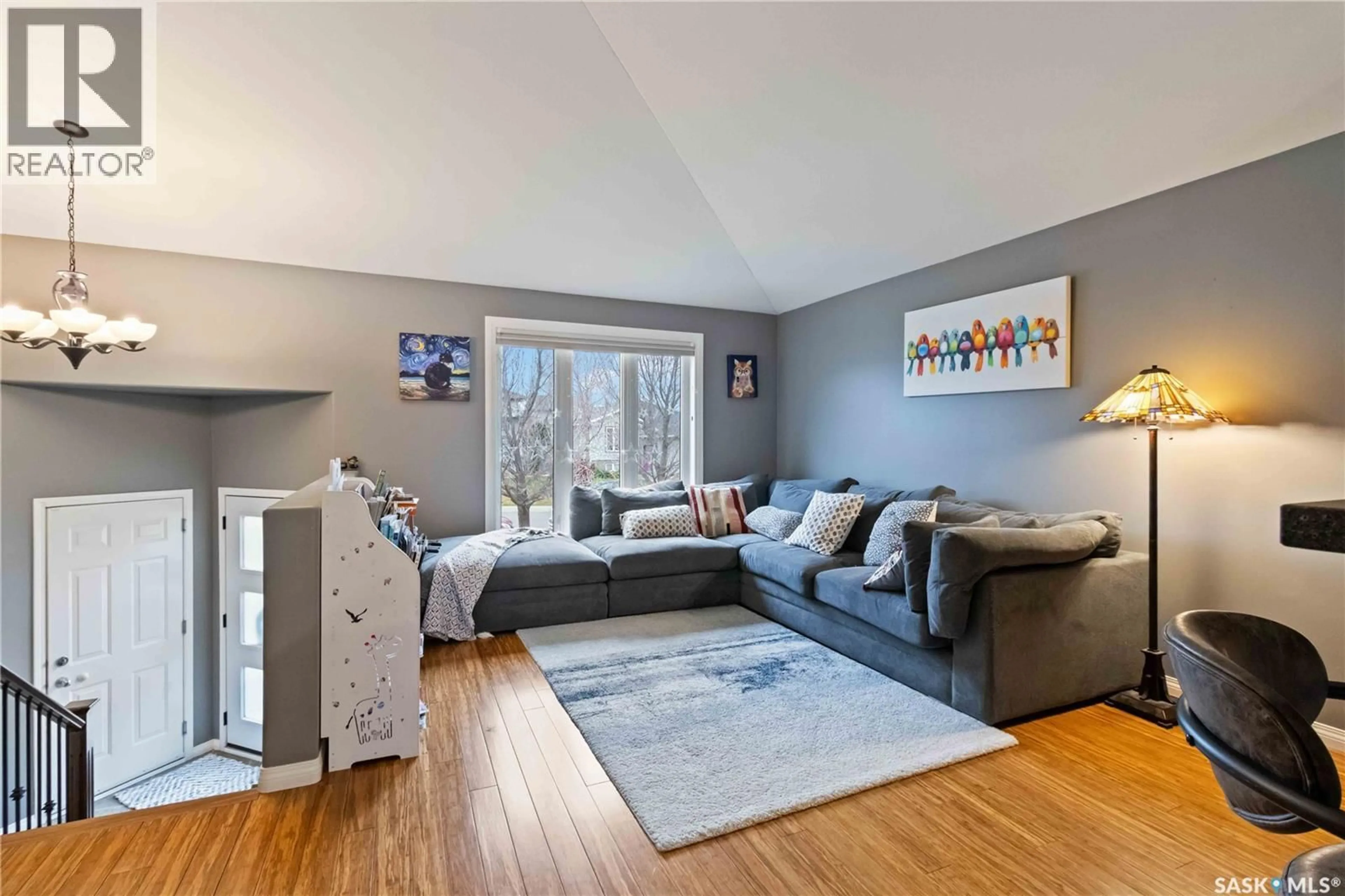 Living room with furniture, wood/laminate floor for 506 KUCEY CRESCENT, Saskatoon Saskatchewan S7N4T3