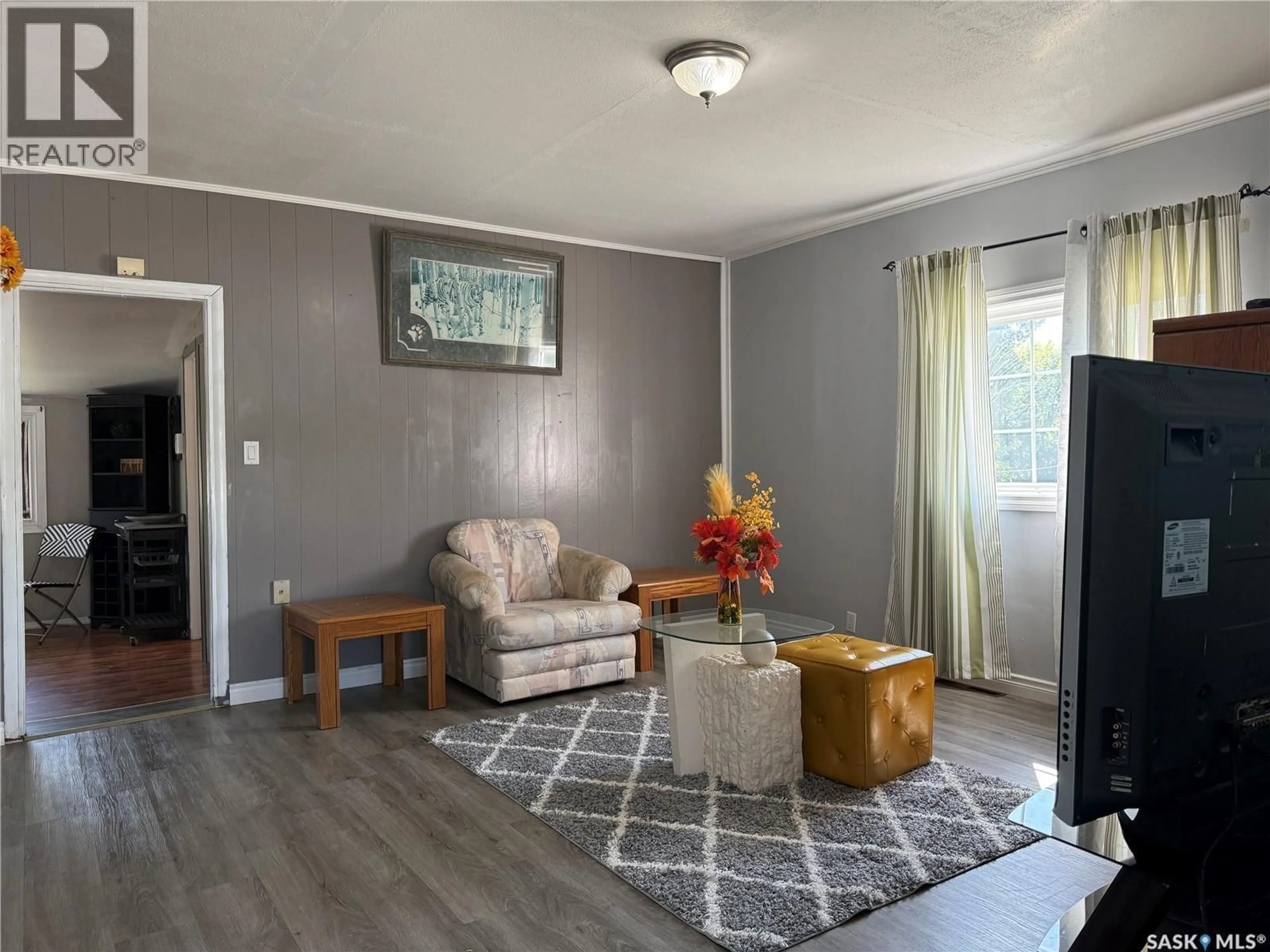 Living room with furniture, wood/laminate floor for 573 4TH AVENUE, Melville Saskatchewan S0A2P0
