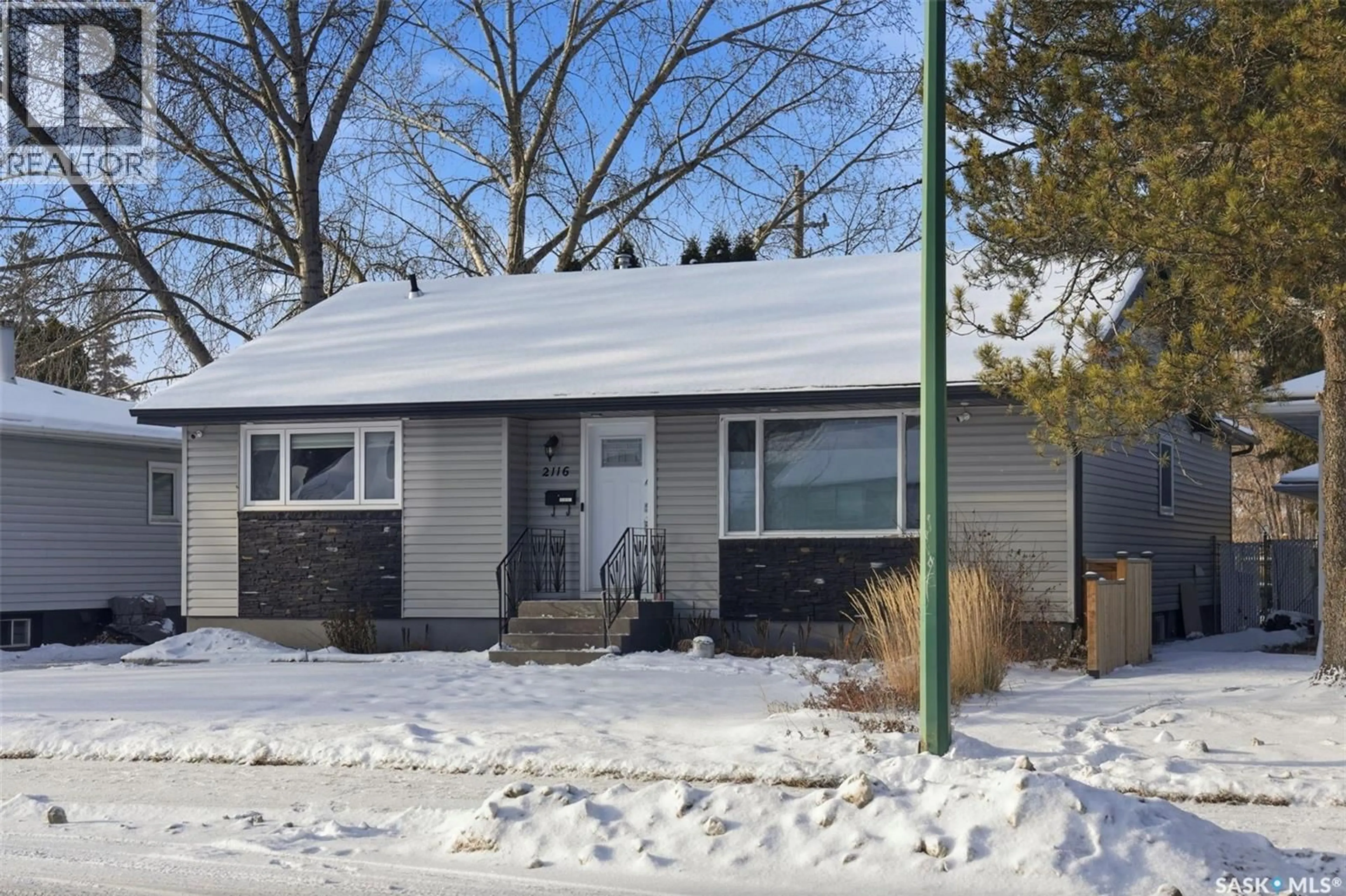 Home with vinyl exterior material, street for 2116 CUMBERLAND AVENUE, Saskatoon Saskatchewan S7J1Z3