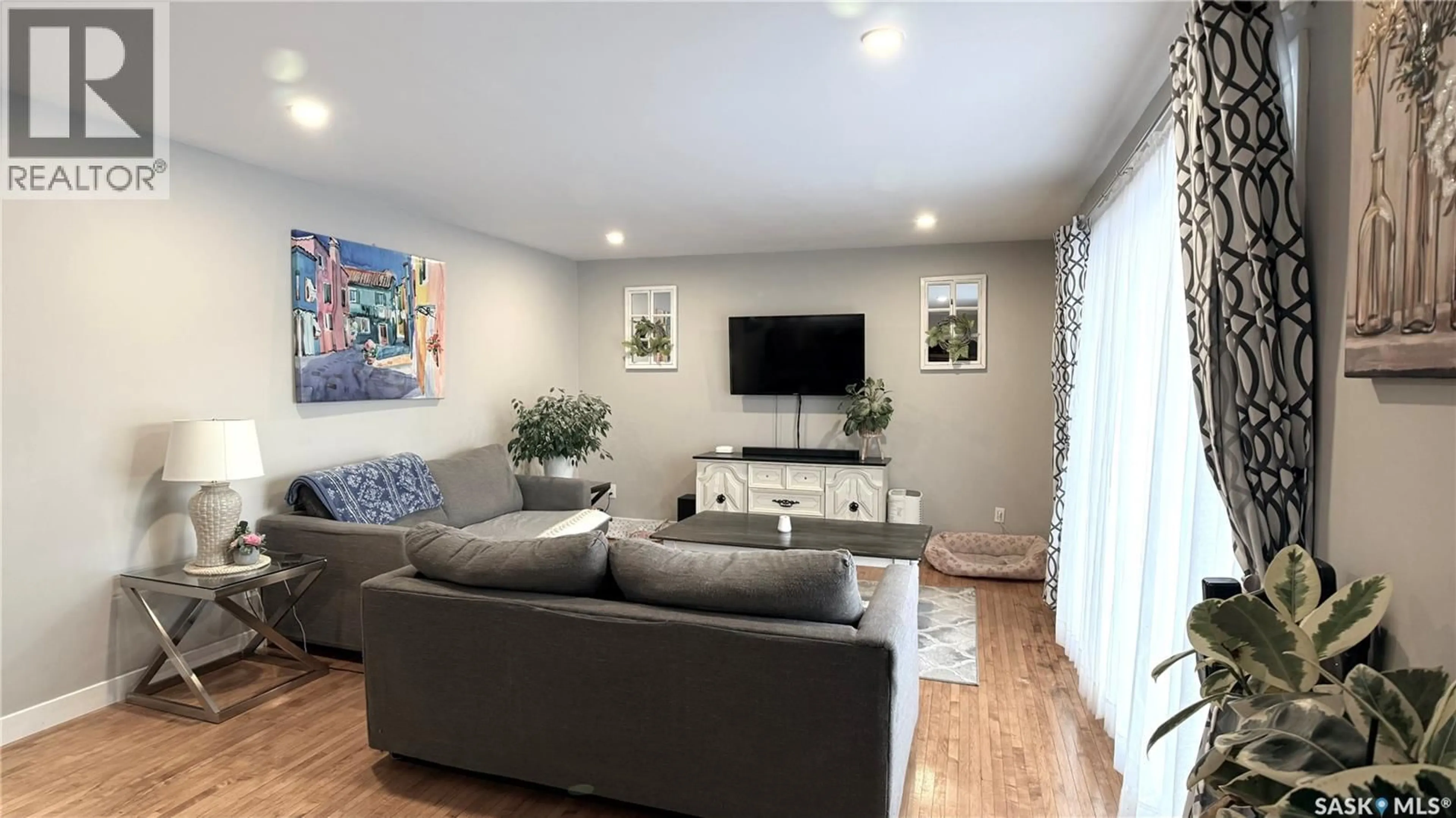 Living room with furniture, wood/laminate floor for 6 RATTRAY PLACE, Estevan Saskatchewan S4A0J7