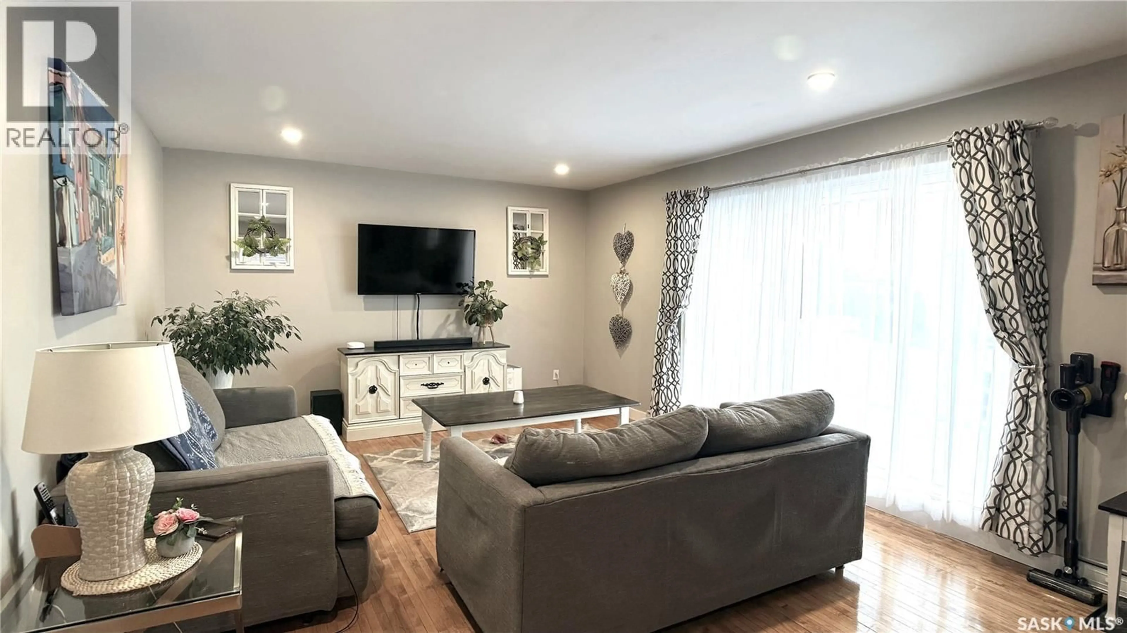 Living room with furniture, wood/laminate floor for 6 RATTRAY PLACE, Estevan Saskatchewan S4A0J7