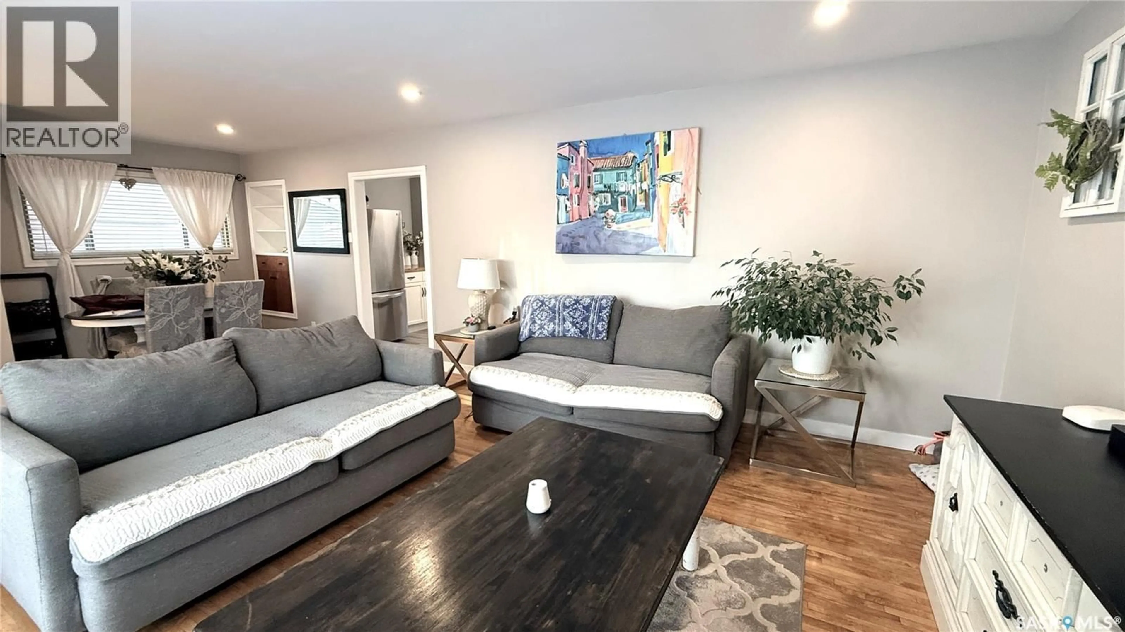 Living room with furniture, wood/laminate floor for 6 RATTRAY PLACE, Estevan Saskatchewan S4A0J7