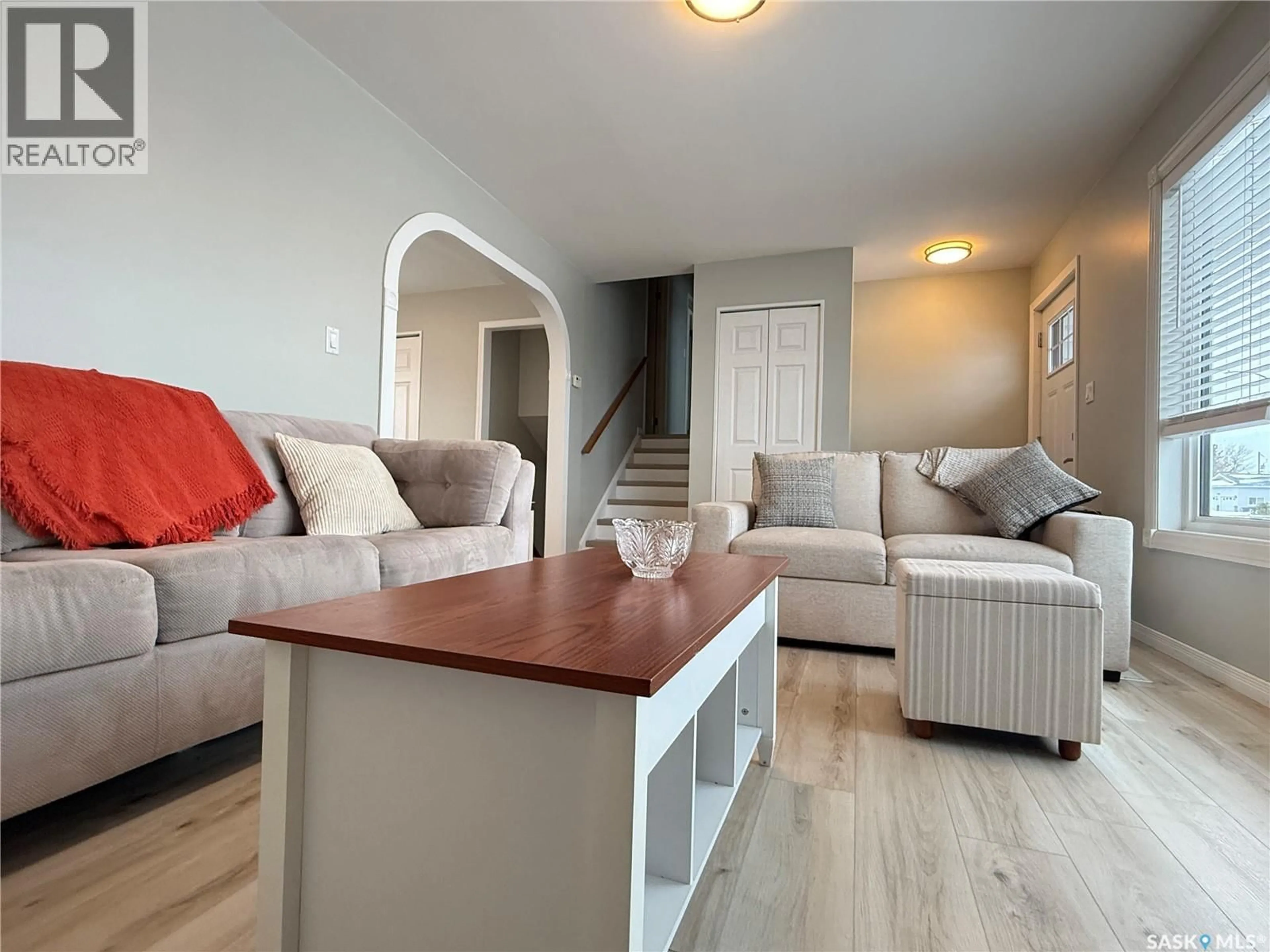 Living room with furniture, wood/laminate floor for 11 QUEBEC DRIVE, Melville Saskatchewan S0A2P0