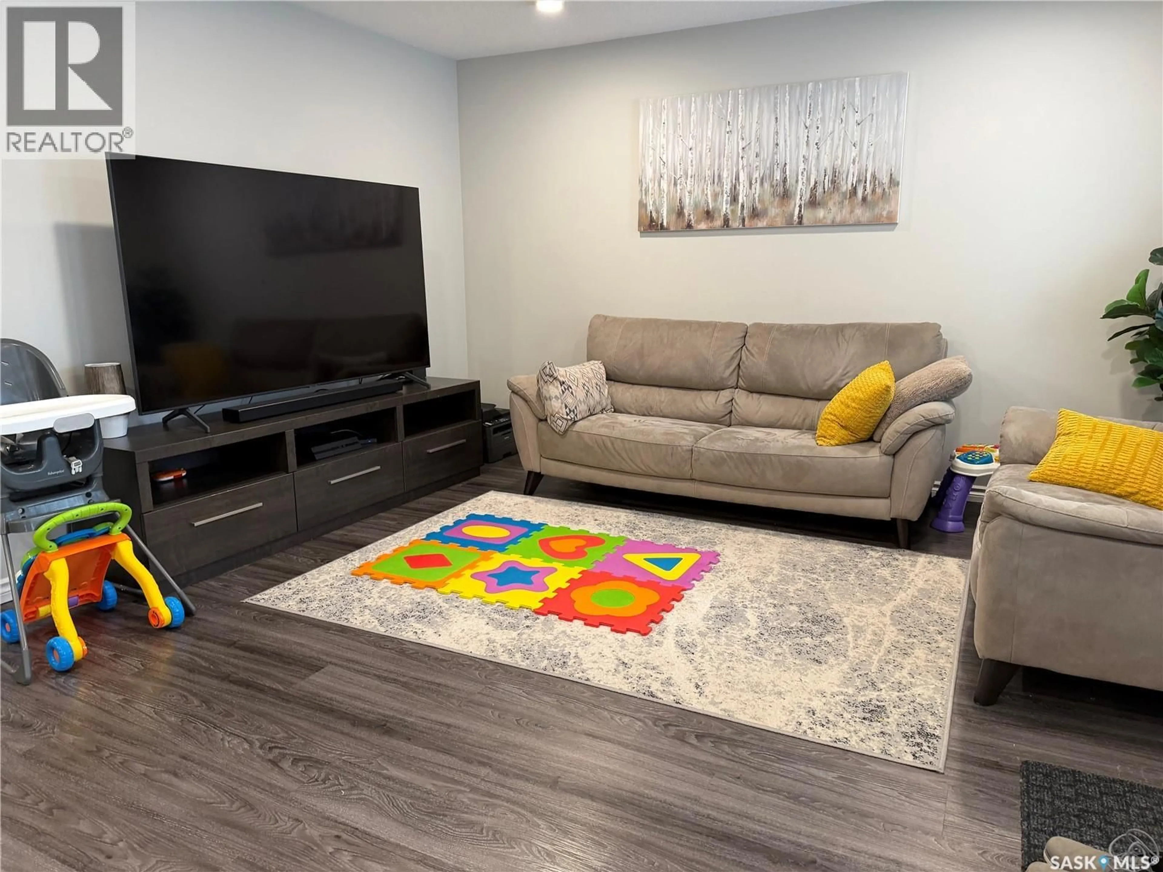 Living room with furniture, unknown for 201 110 AKHTAR BEND, Saskatoon Saskatchewan S7W0Y9