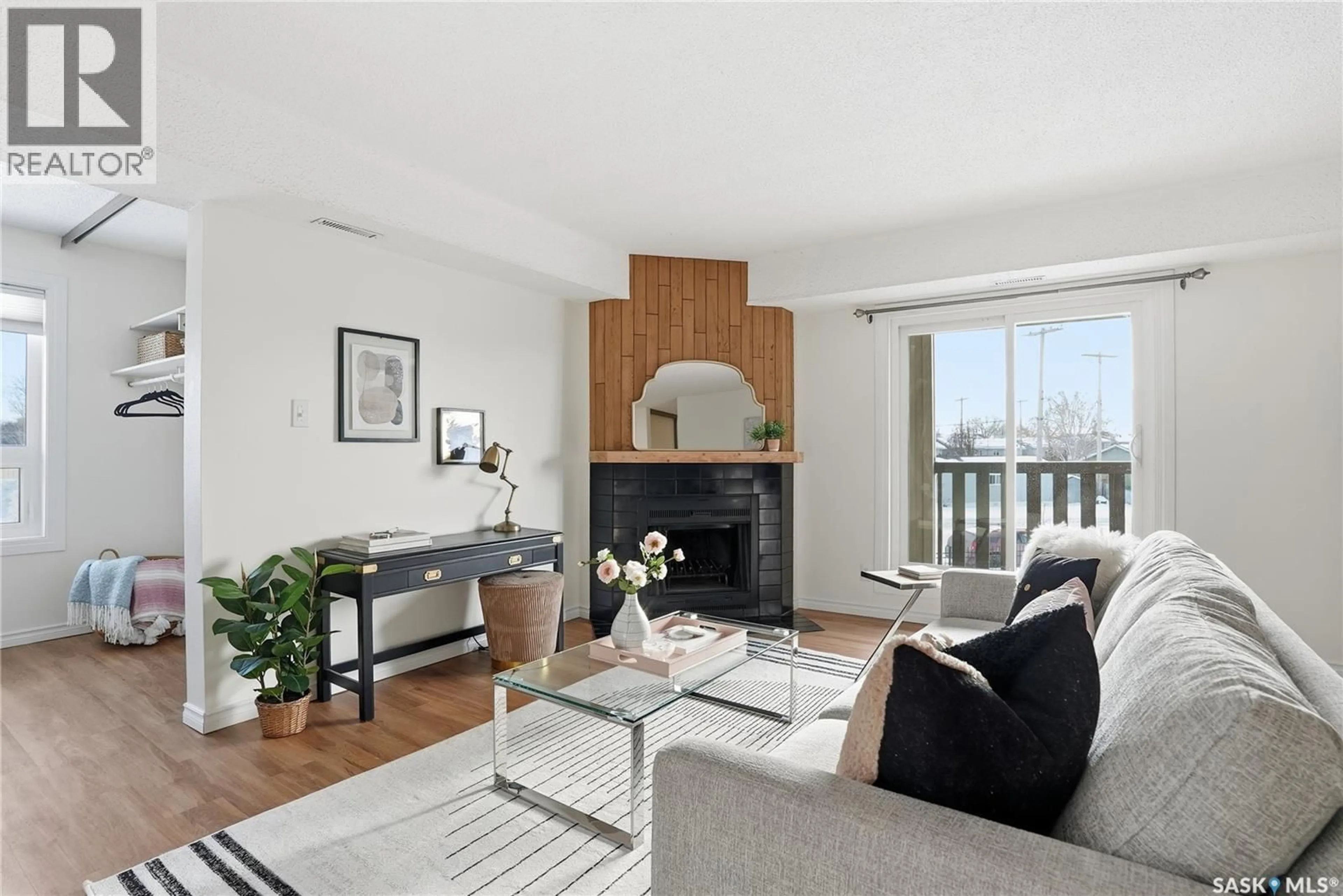 Living room with furniture, wood/laminate floor for 510 - 524 PRAIRIE AVENUE, Saskatoon Saskatchewan S7N2V4