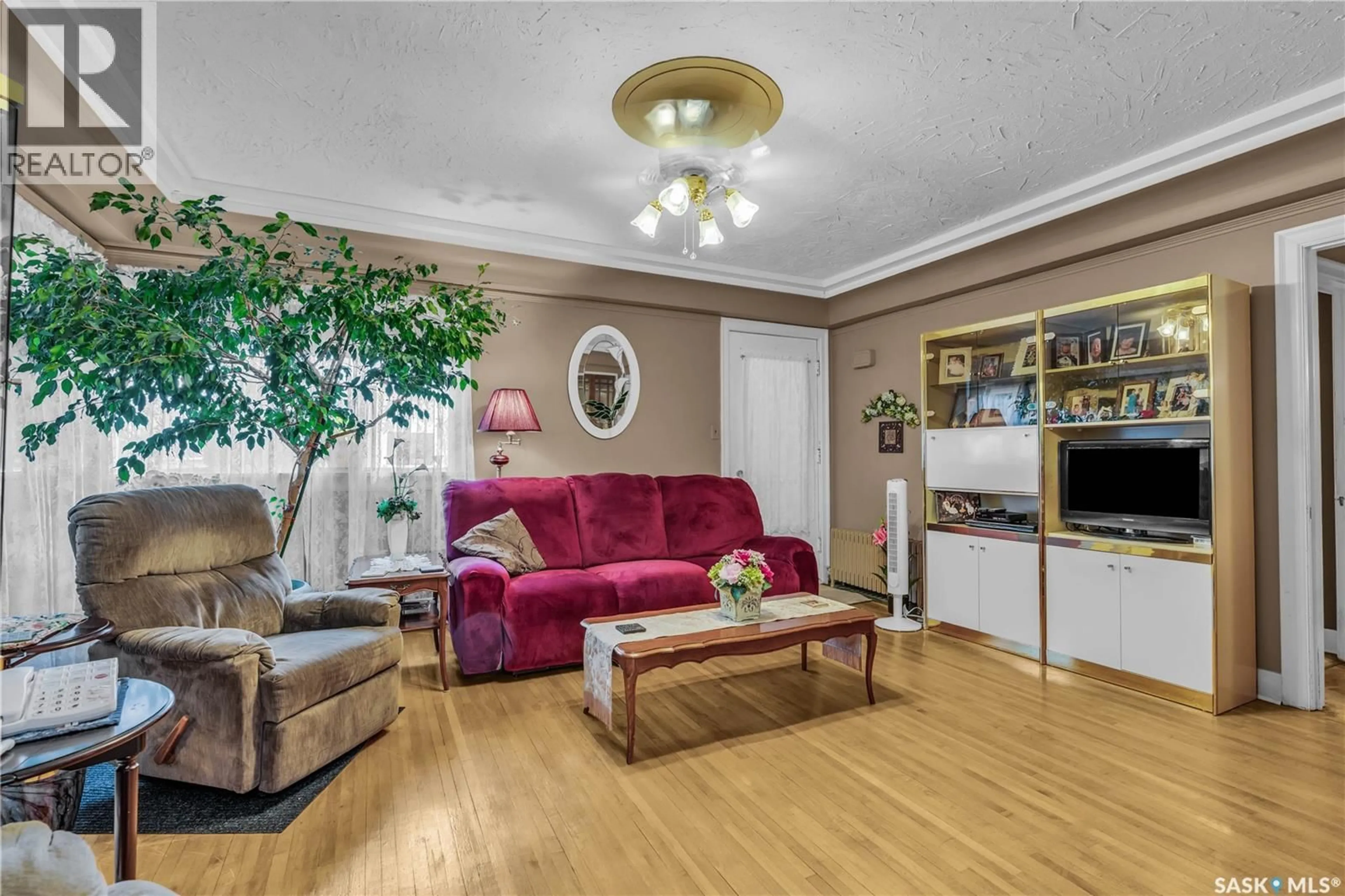 Living room with furniture, wood/laminate floor for 1262 103RD STREET, North Battleford Saskatchewan S9A1K8