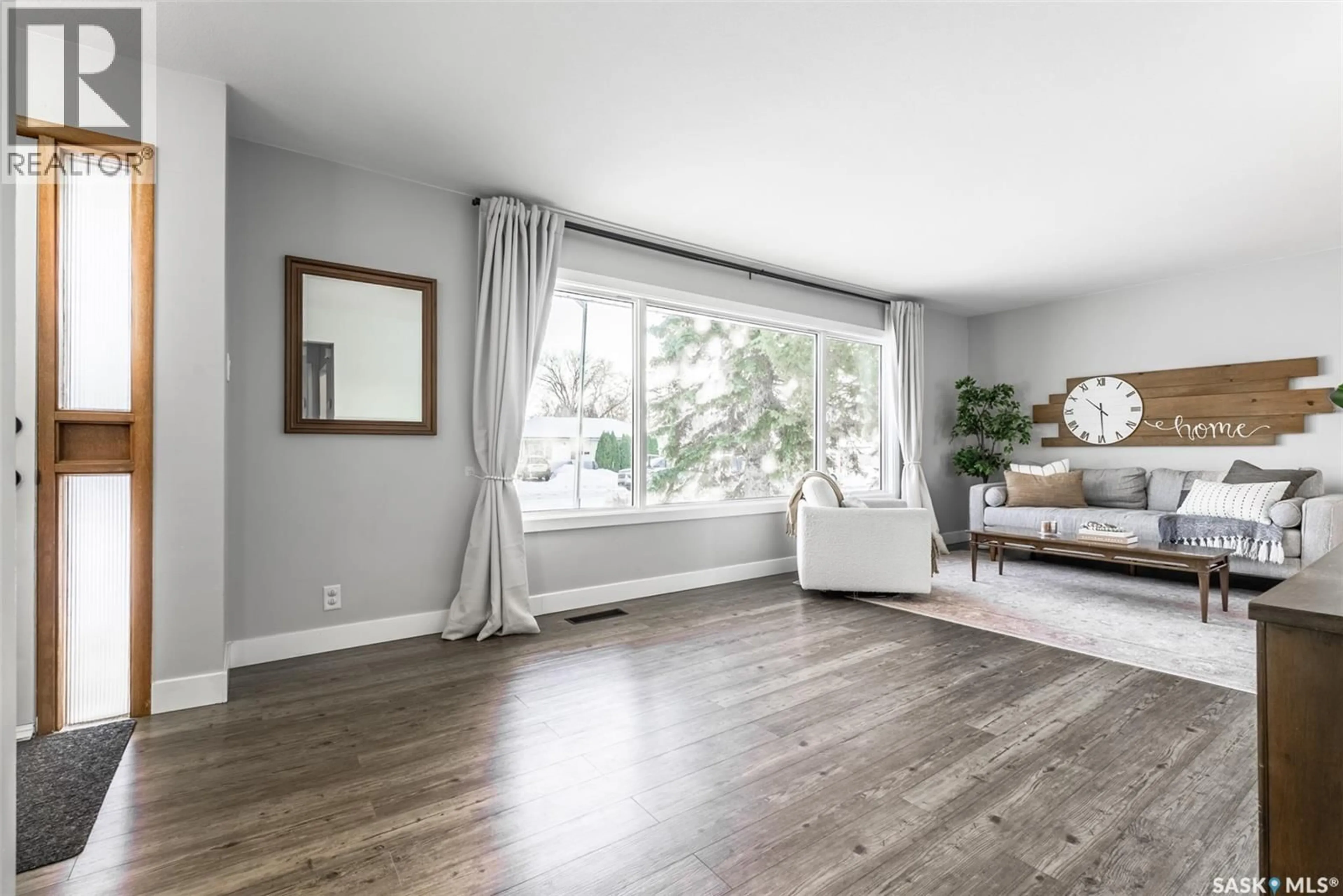 Living room with furniture, wood/laminate floor for 2616 HAULTAIN AVENUE, Saskatoon Saskatchewan S7J1R6