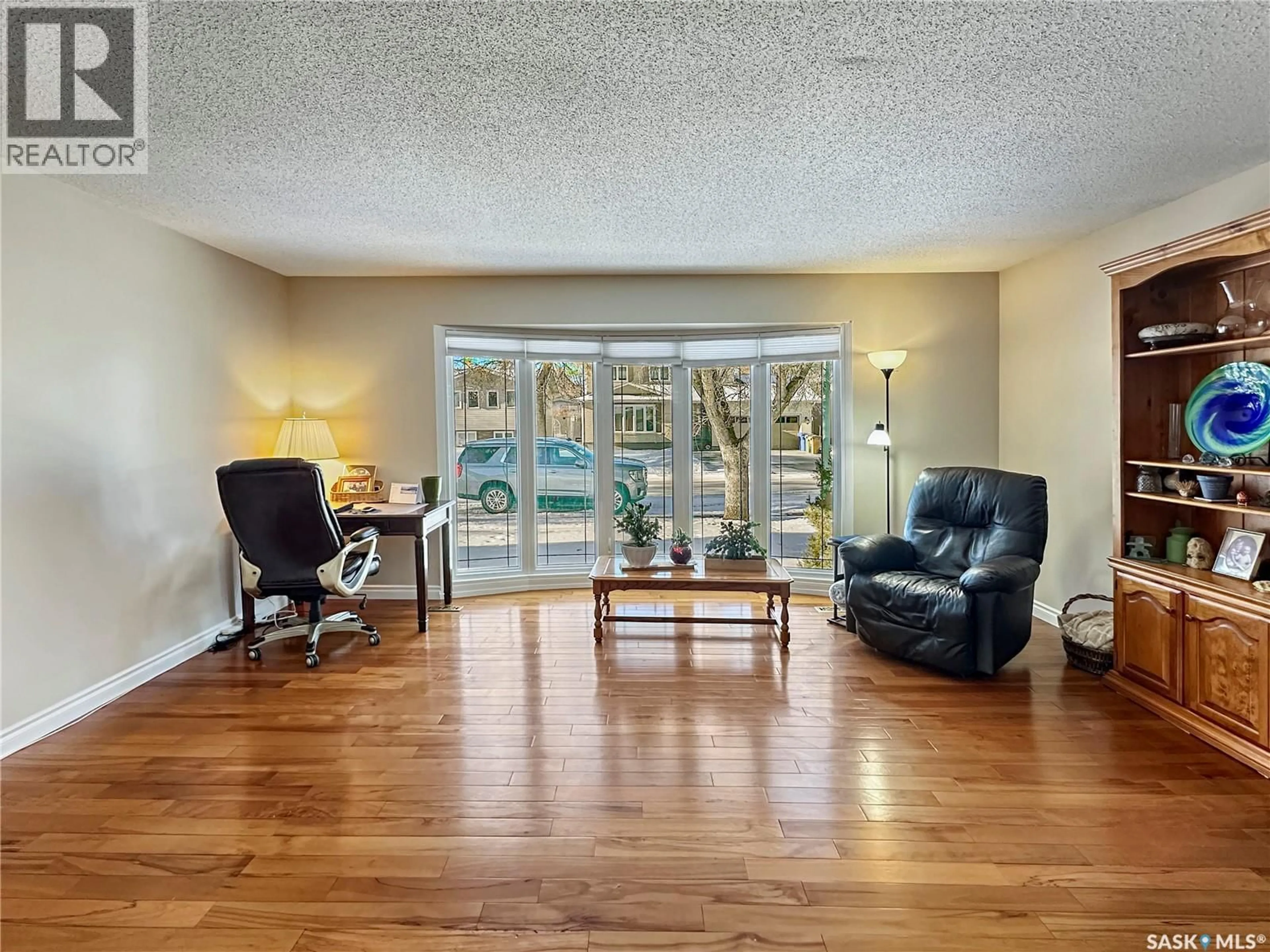 Living room with furniture, wood/laminate floor for 19 MARQUIS CRESCENT, Regina Saskatchewan S5S6J8