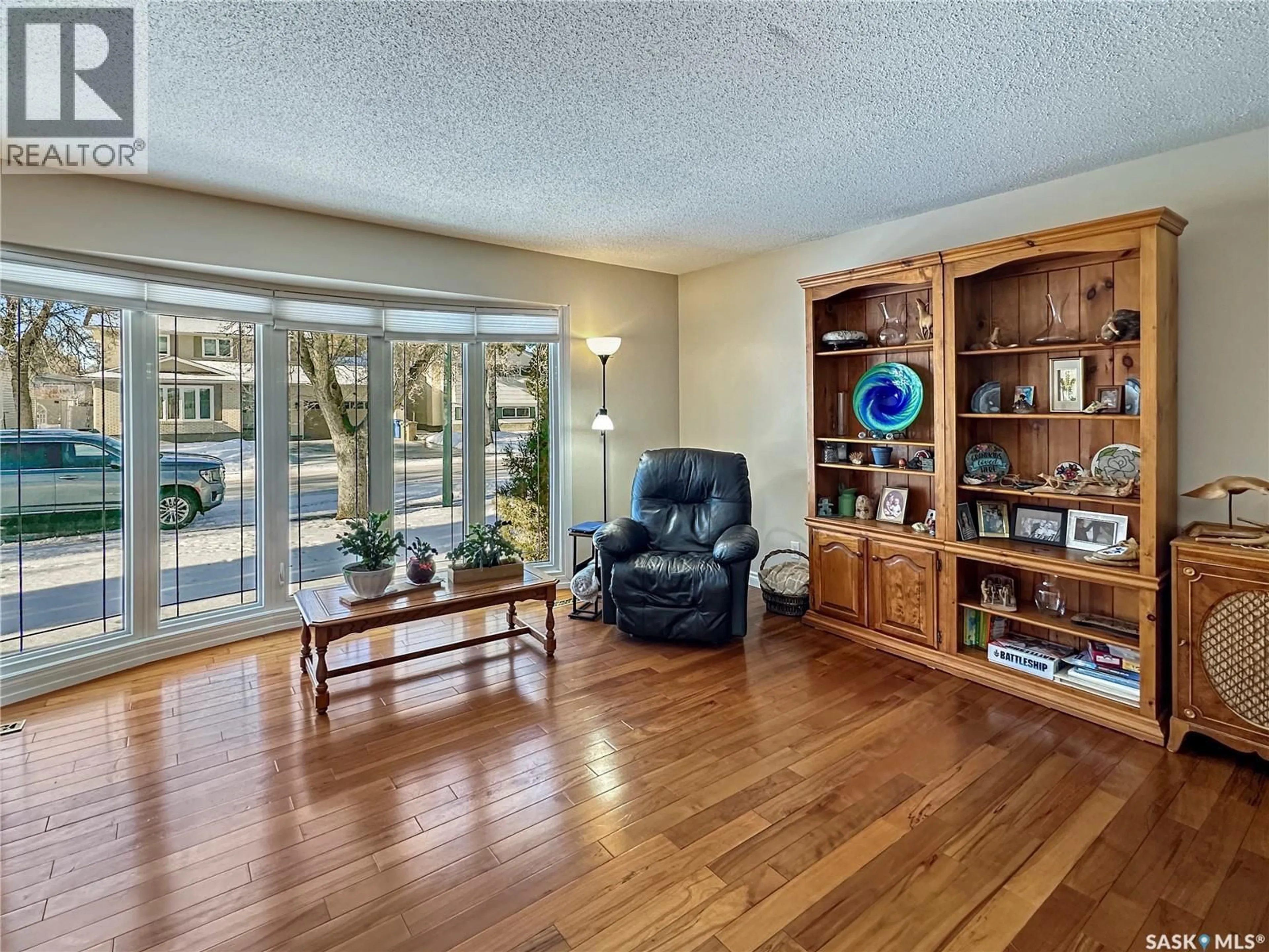 Living room with furniture, wood/laminate floor for 19 MARQUIS CRESCENT, Regina Saskatchewan S5S6J8