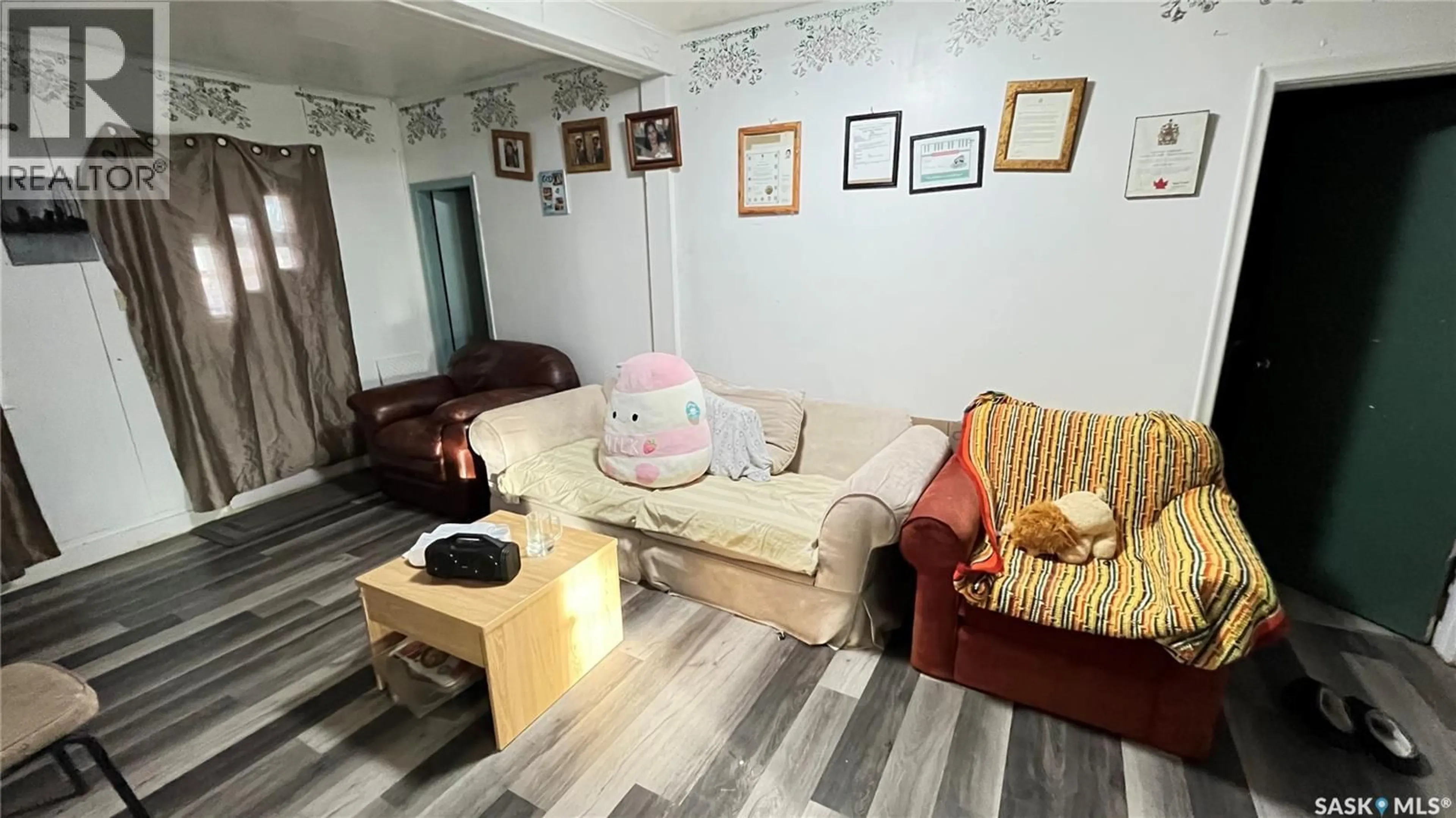 Living room with furniture, wood/laminate floor for 46 PACIFIC AVENUE, Maple Creek Saskatchewan S0N1N0