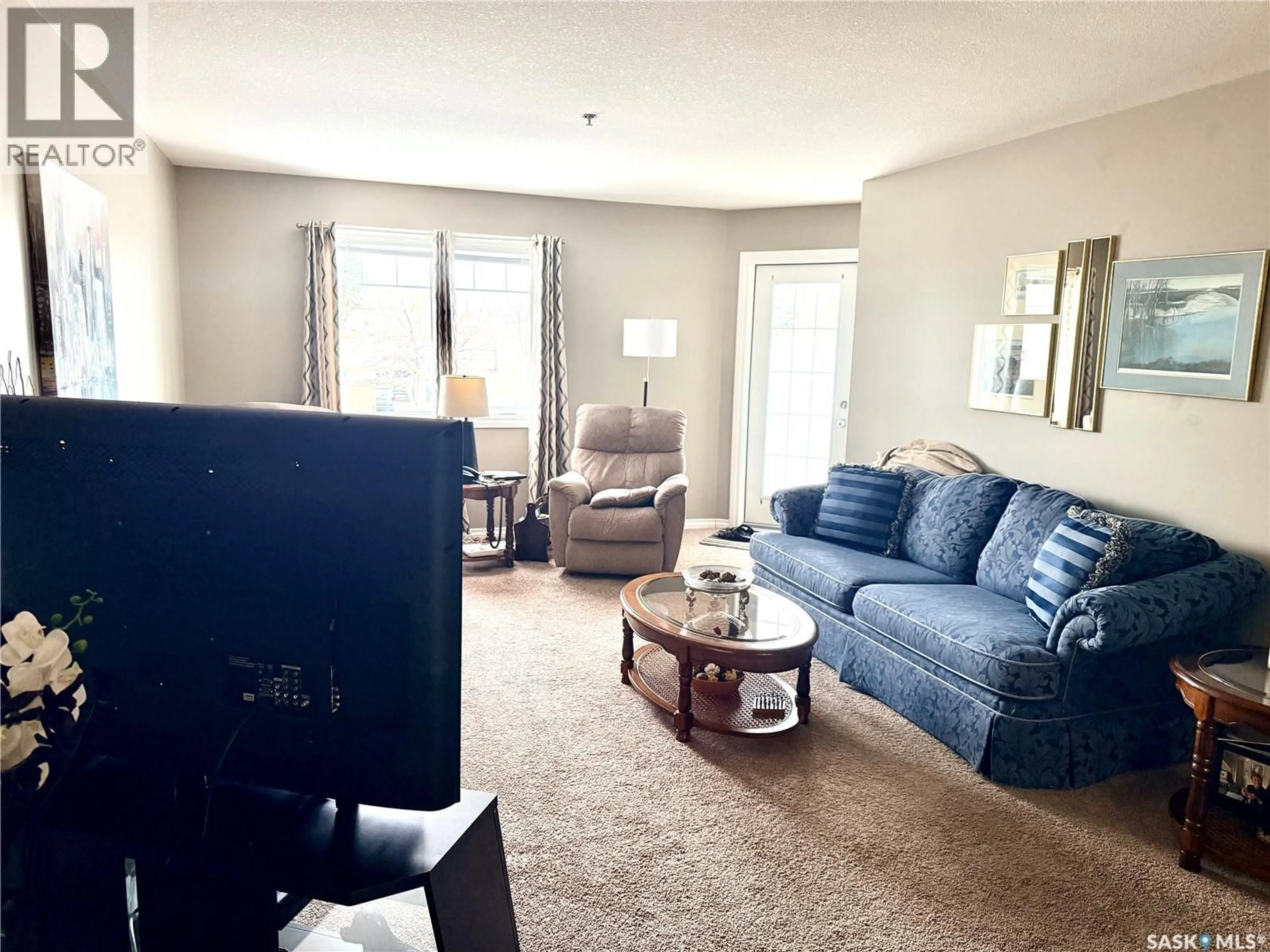 Living room with furniture, carpet floor for 107 - 6345 ROCHDALE BOULEVARD, Regina Saskatchewan S4X2R1