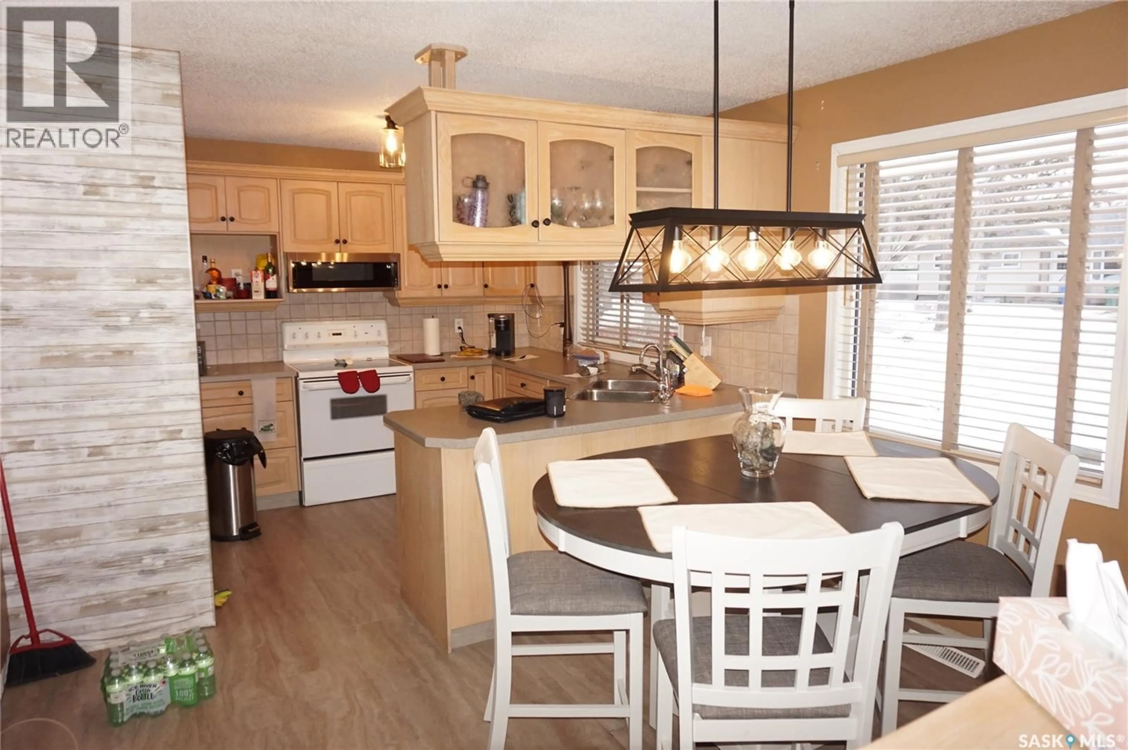 Open concept kitchen, wood/laminate floor for 4452 ACADIA DRIVE, Regina Saskatchewan S4S4T4
