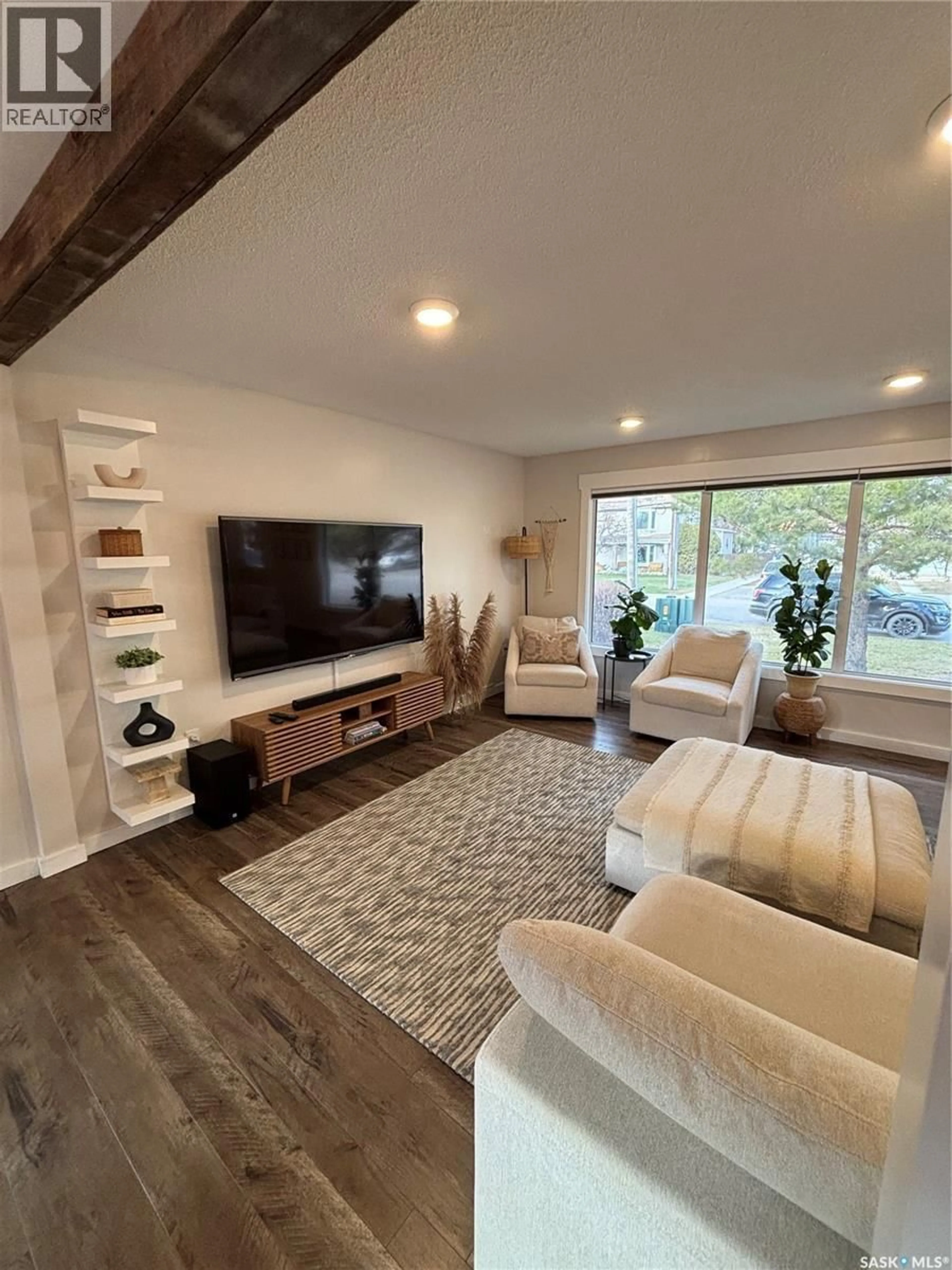 Living room with furniture, wood/laminate floor for 845 PROSPECT AVENUE, Oxbow Saskatchewan S0C2B0