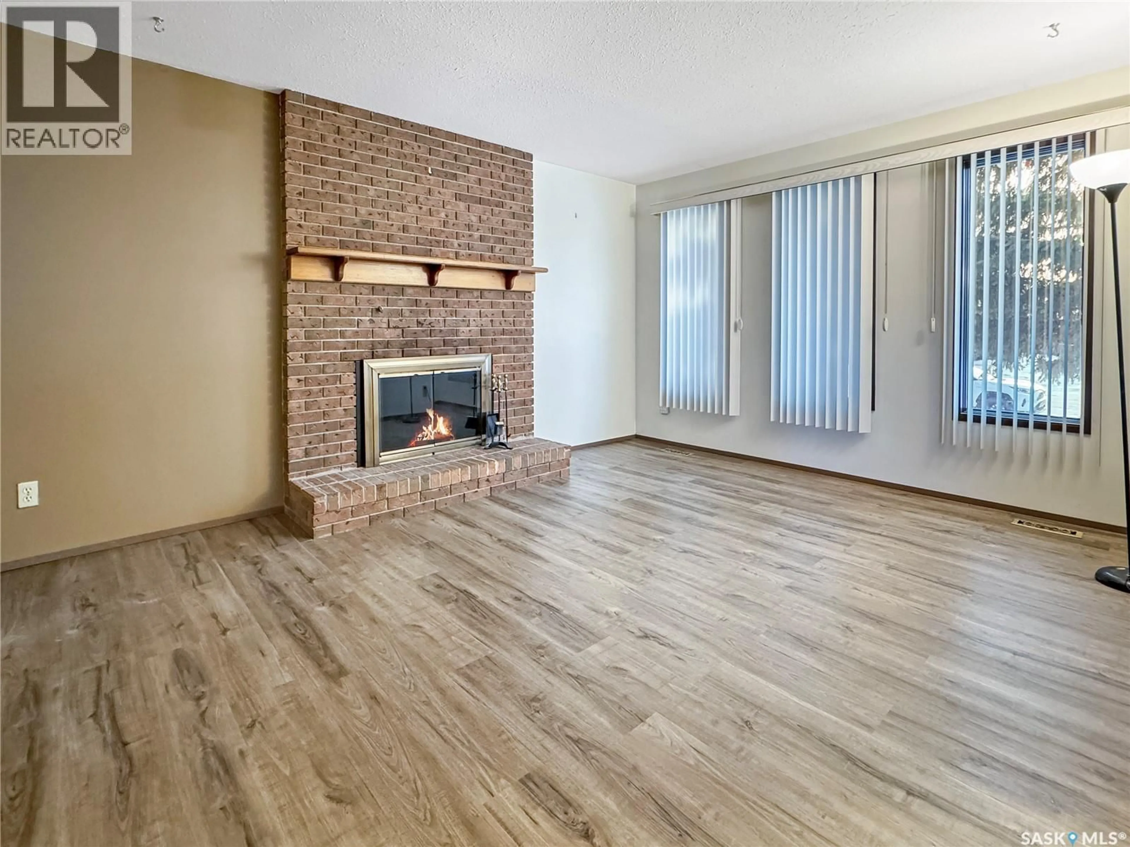 Living room with furniture, wood/laminate floor for 11342 CLARK DRIVE, North Battleford Saskatchewan S9A3P3