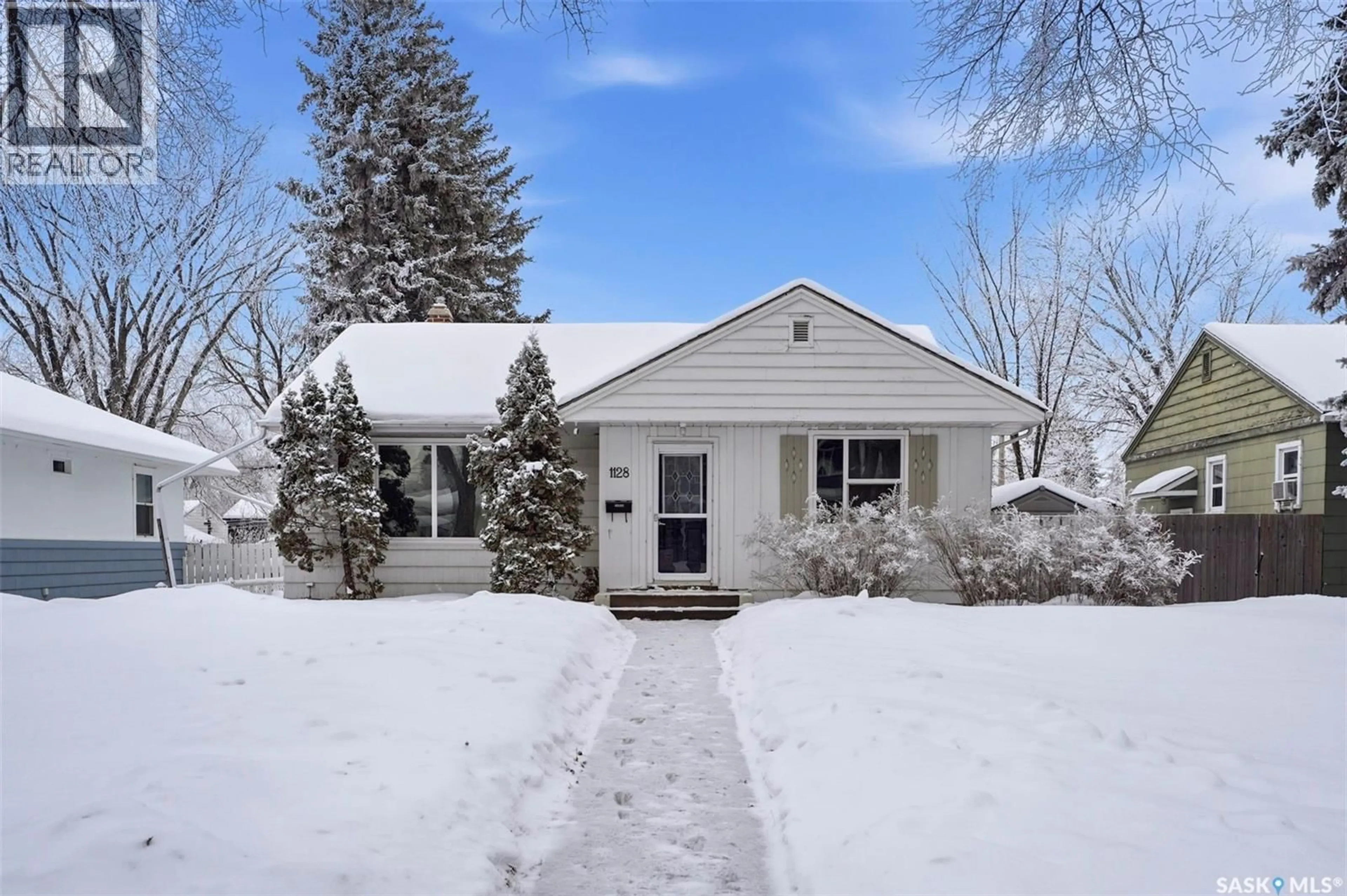 Home with vinyl exterior material, street for 1128 4TH STREET, Saskatoon Saskatchewan S7H1K8