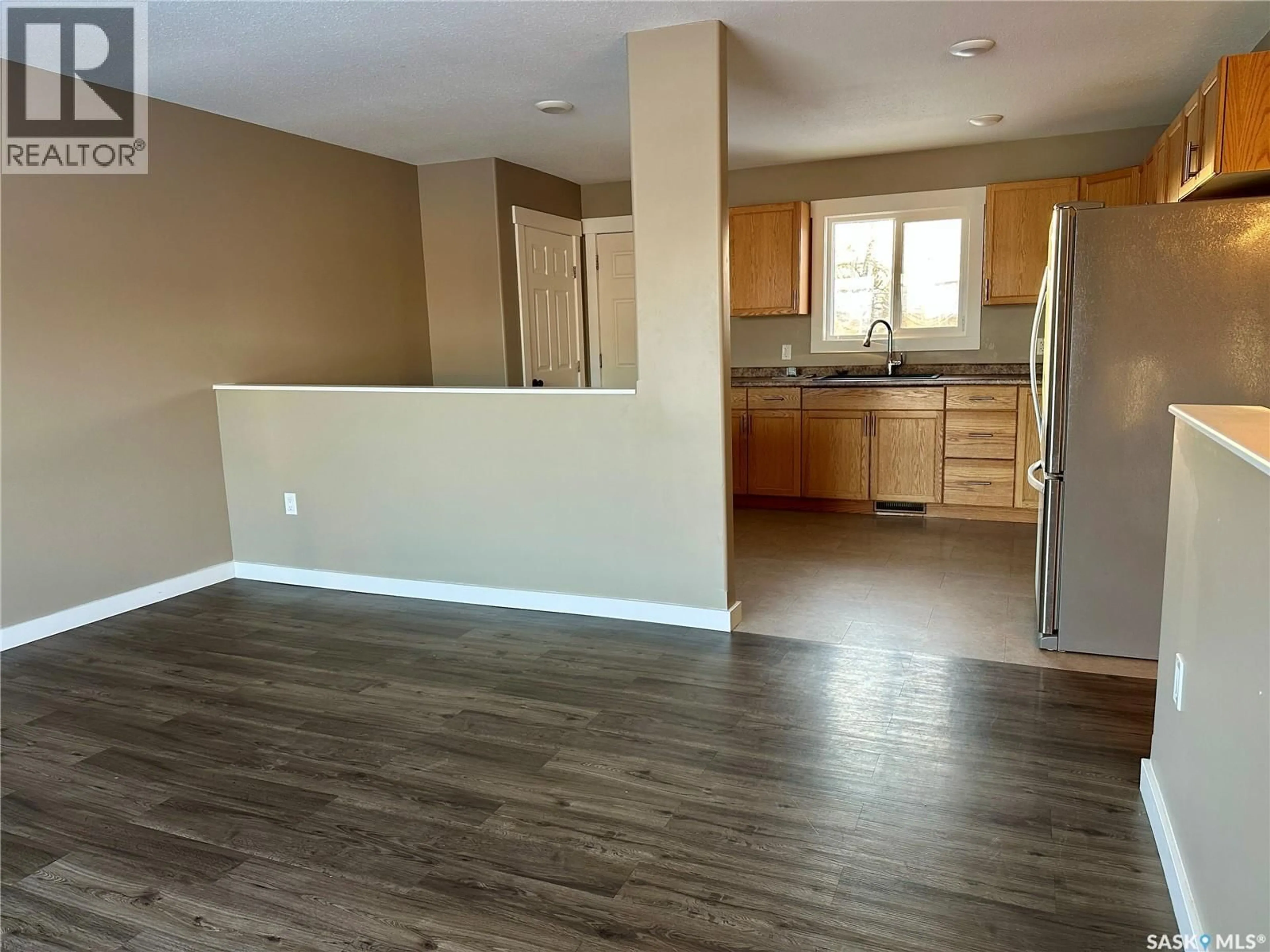 Open concept kitchen, wood/laminate floor for 595 COOK CRESCENT, La Ronge Saskatchewan S0J1L0